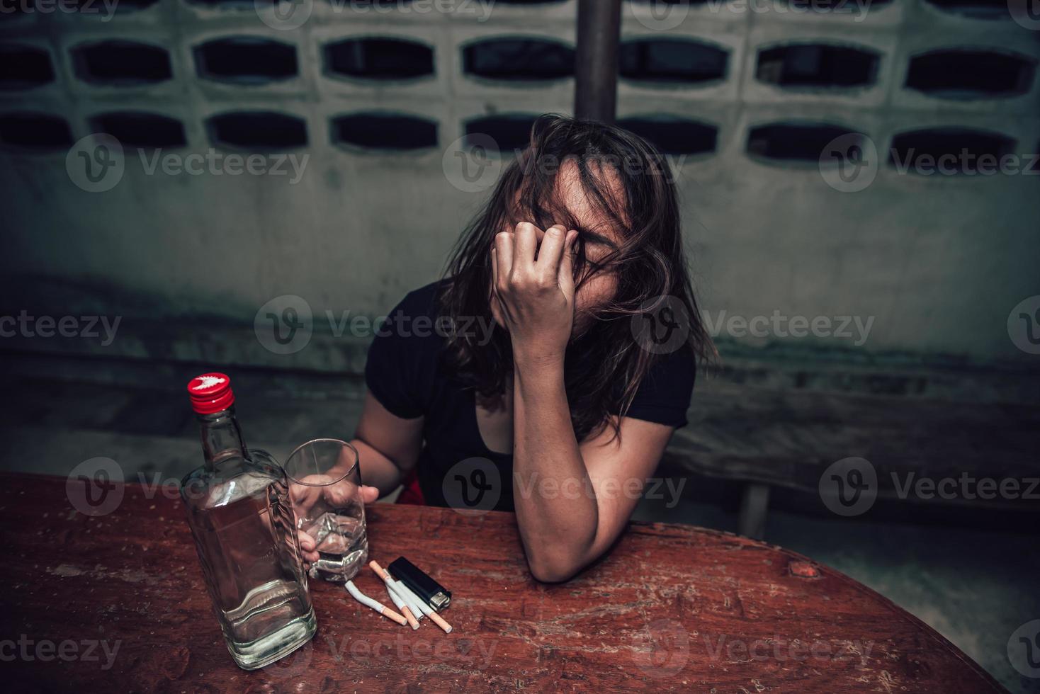 Asian woman drink vodka alone at home on night time,Thailand people,Stress woman drunk concept photo