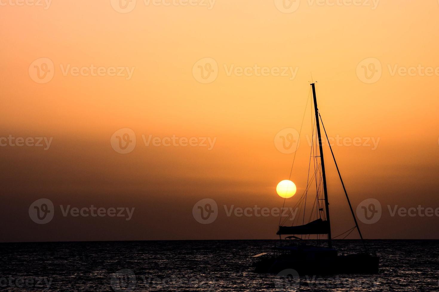 Sailing yacht at sunset photo