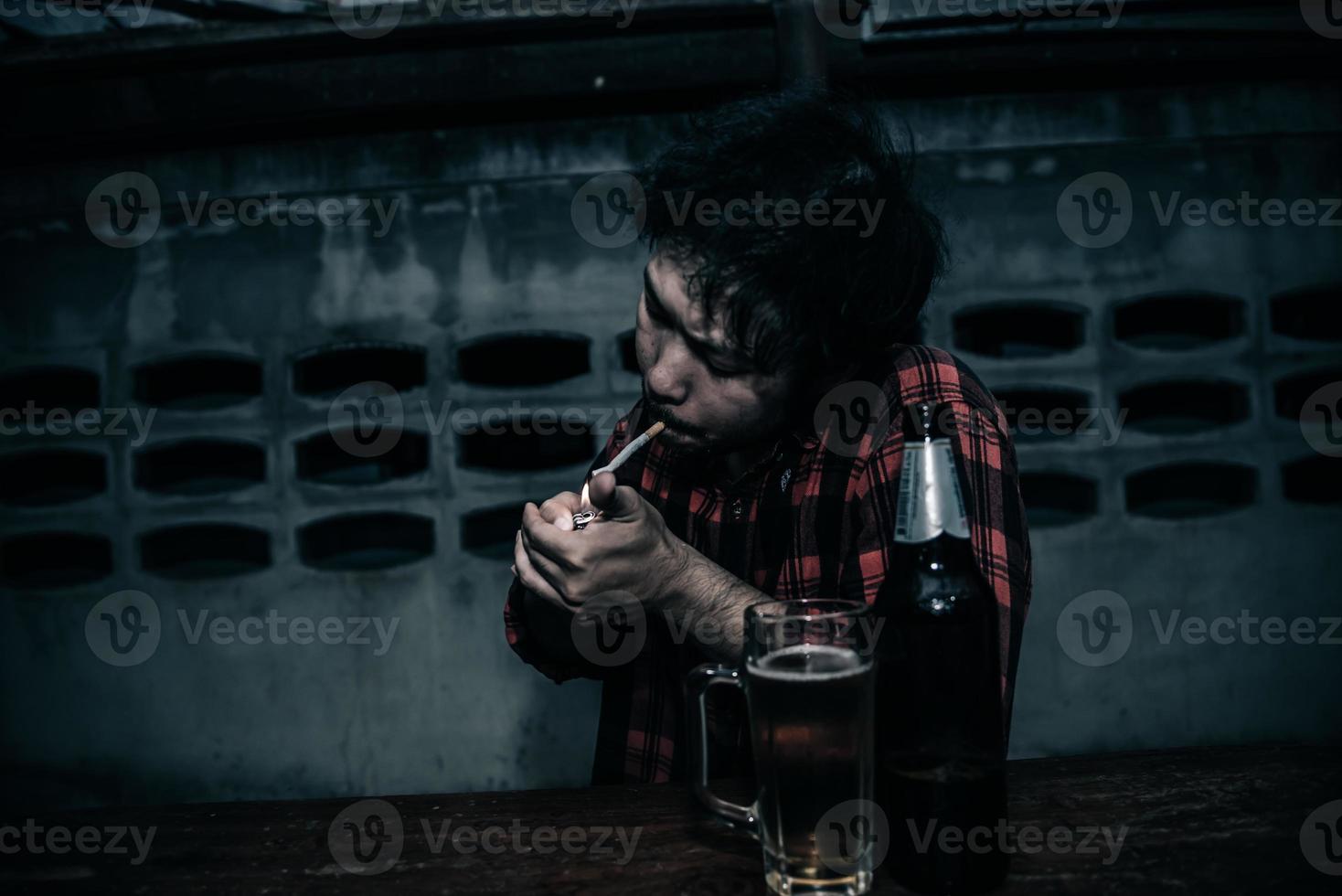 Asian man drink vodka alone at home on night time,Thailand people,Stress man drunk concept photo