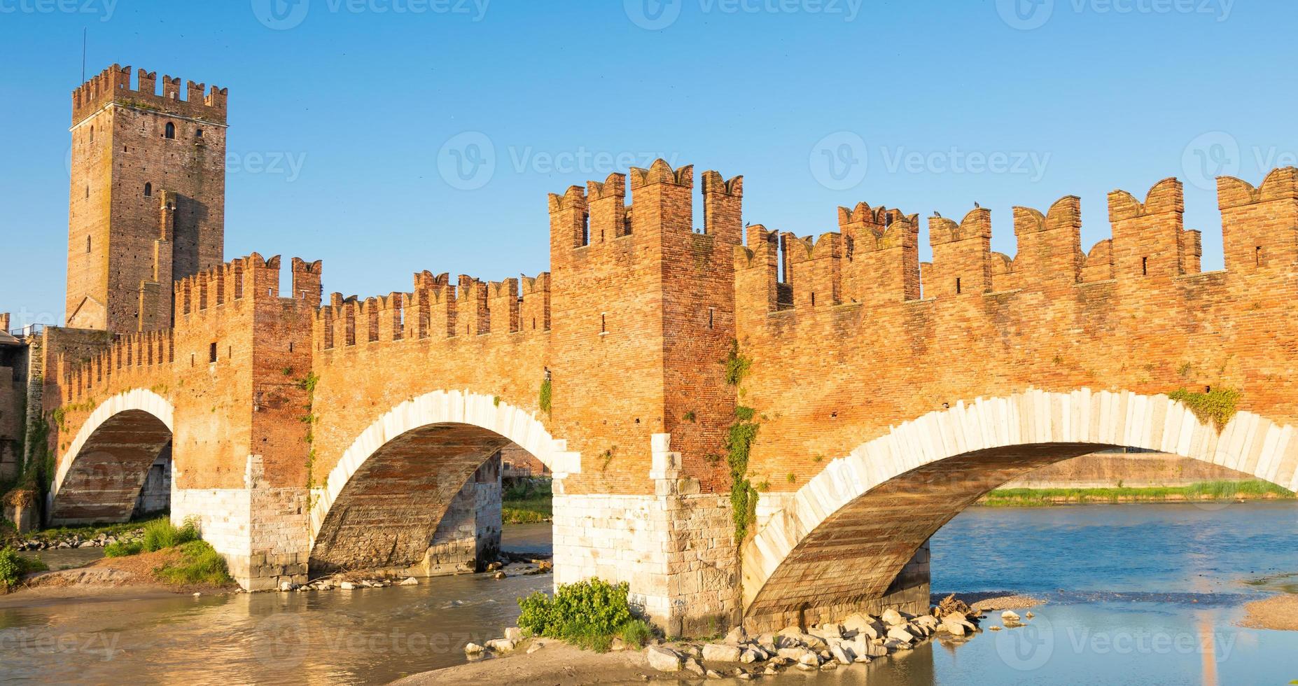 Verona, Italy. Castelvecchio bridge on Adige river. Old castle sightseeing at sunrise. photo