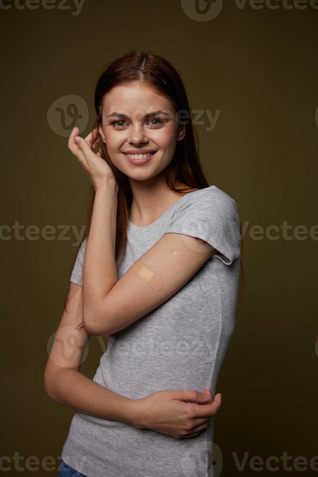 cheerful woman leukoplast on her arm vaccine passport patient Studio photo