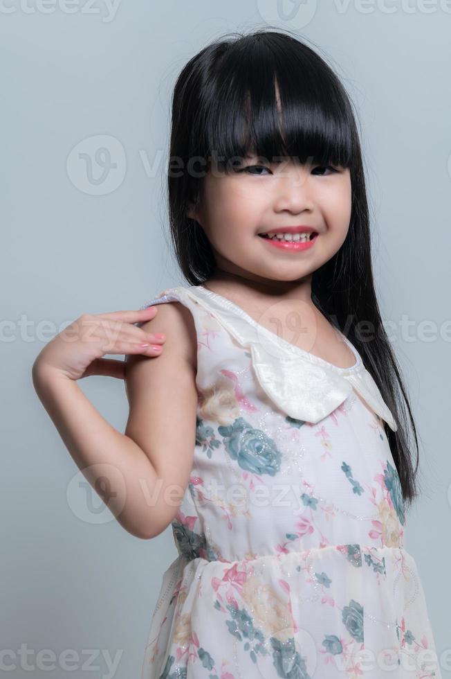 Portrait asian cute little girl pose for take a photo in studio on white background