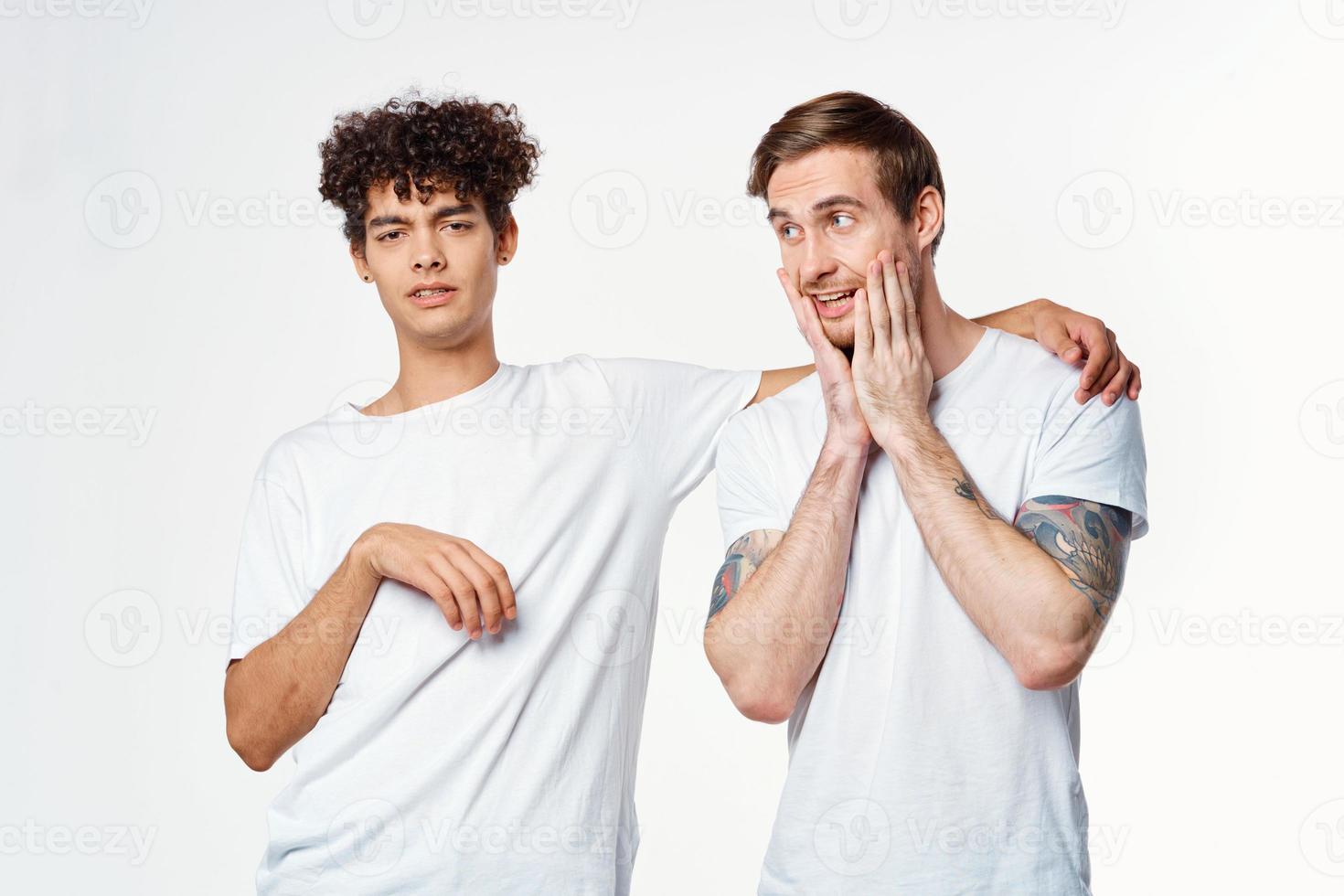 two guys in white t-shirts next to friendship communication emotions photo