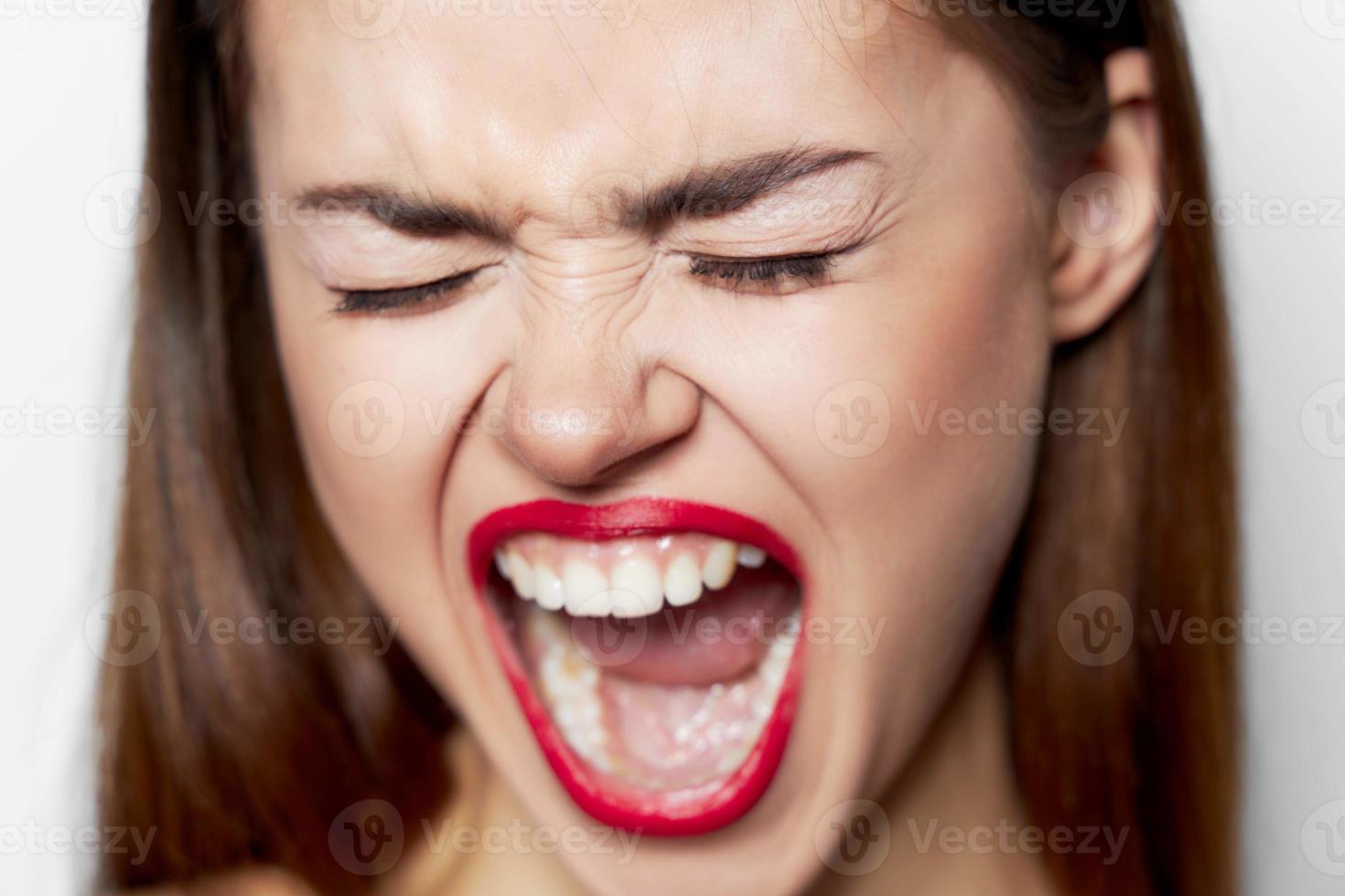 woman with wide open mouth and closed eyes face closeup photo