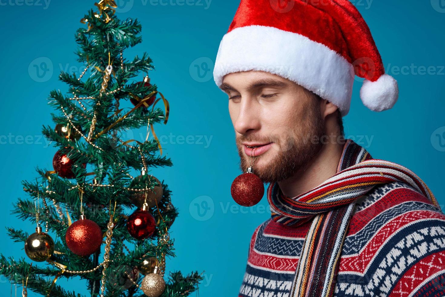 emotional man in a santa hat Christmas decorations holiday New Year red background photo