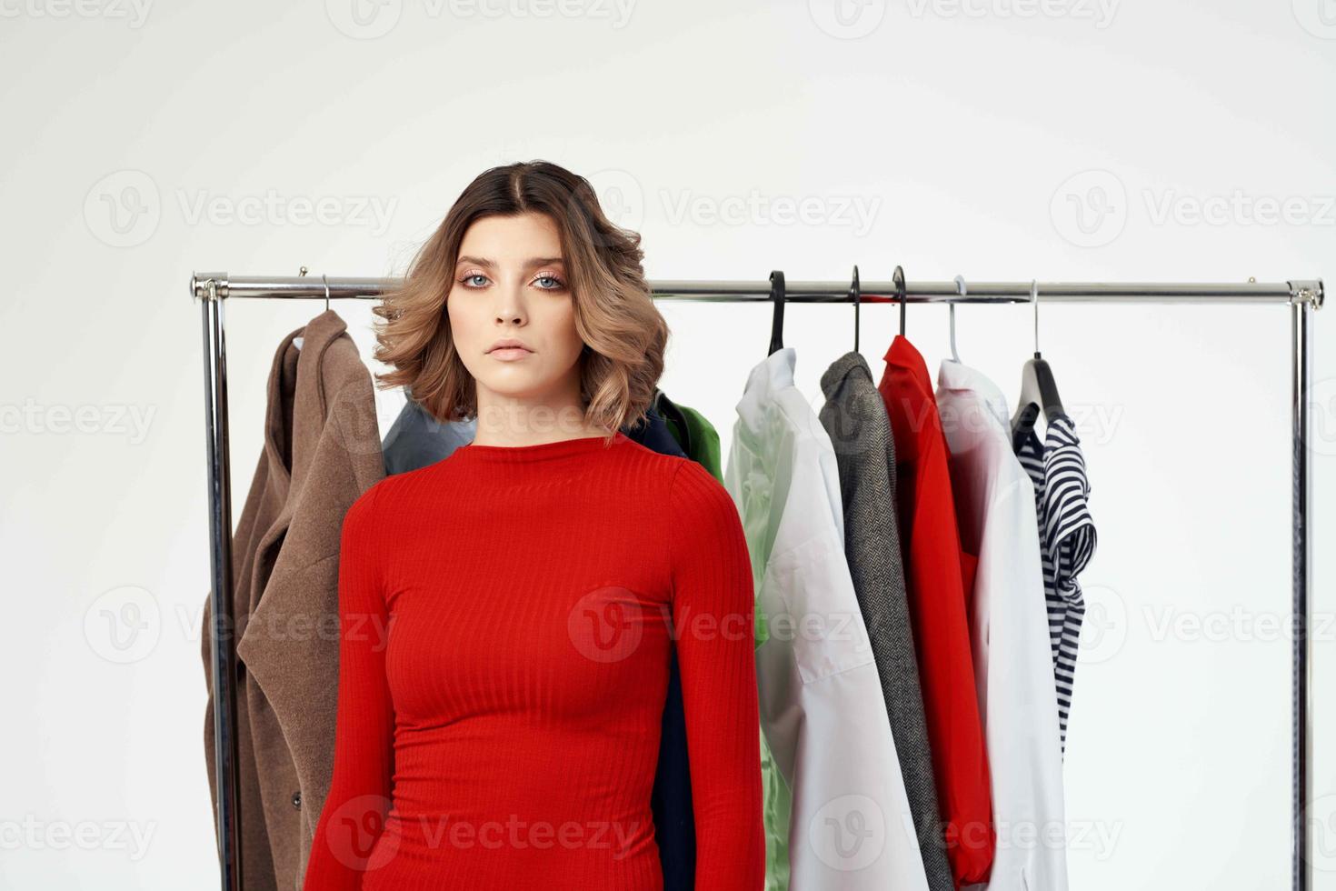 cheerful woman next to clothes fashion fun retail emotions photo