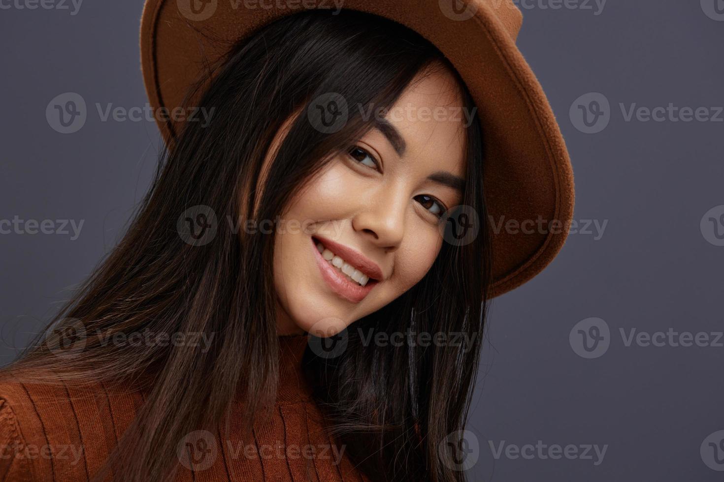 Brunette in Hat fun brown sweater posing casual wear Gray background photo