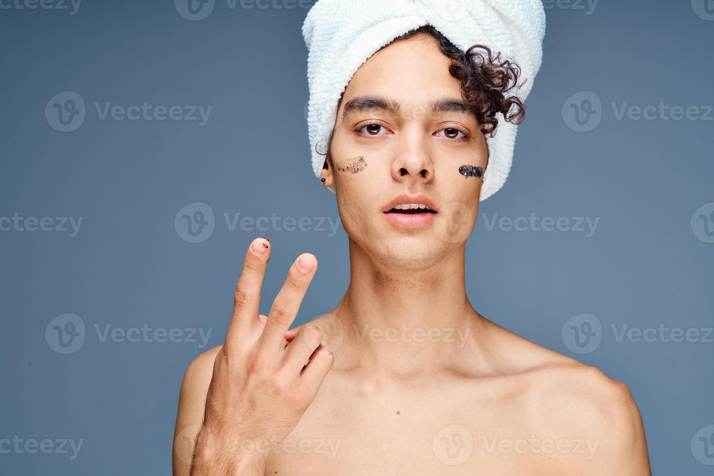 guy with bare shoulders with a towel on his head photo