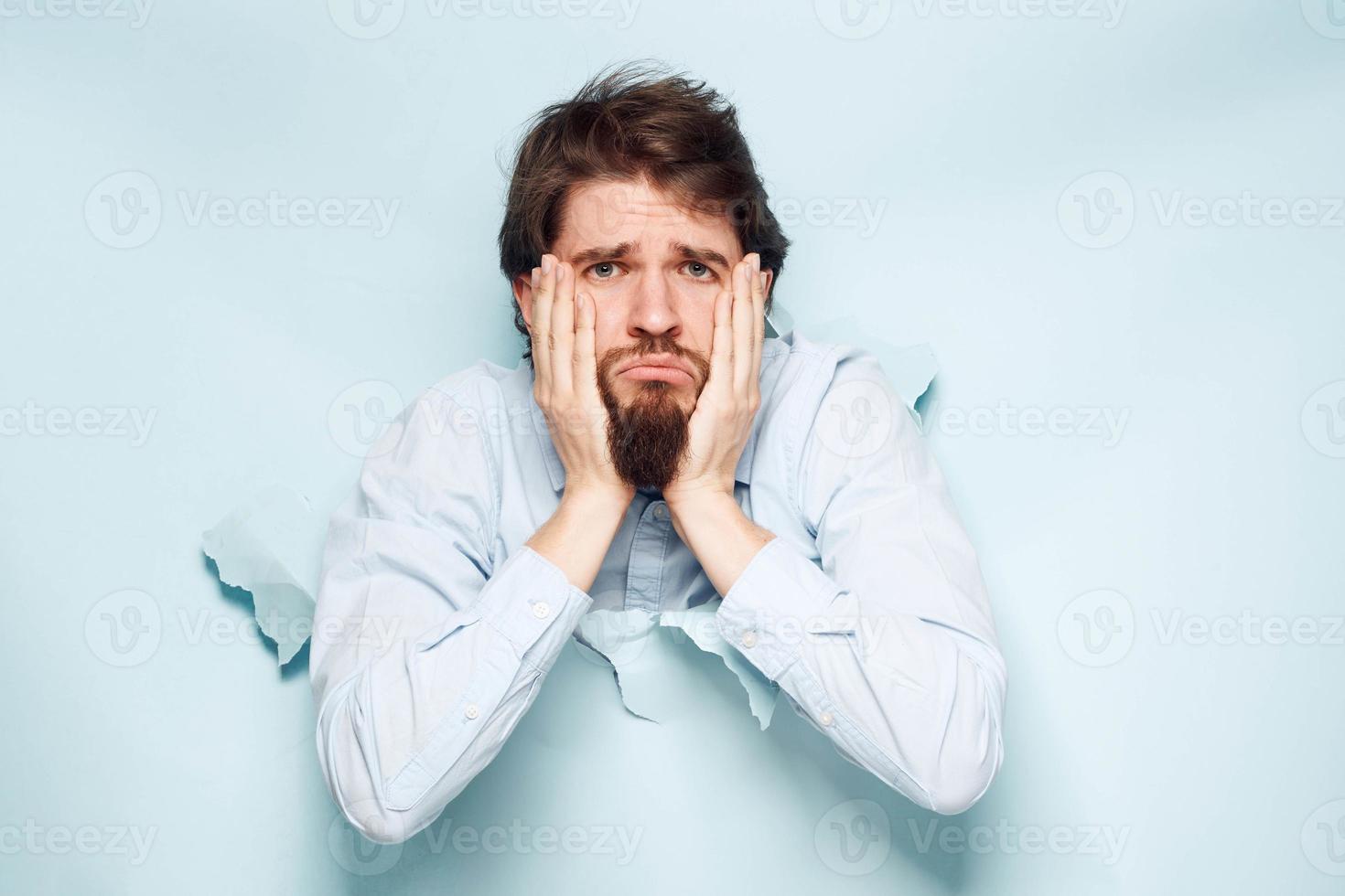 A man in a shirt peeks out from behind the wall of a career work emotions photo