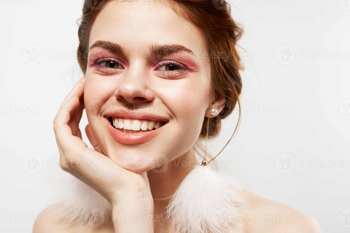 woman with bare shoulders in fluffy earrings jewelry Glamor bright makeup photo
