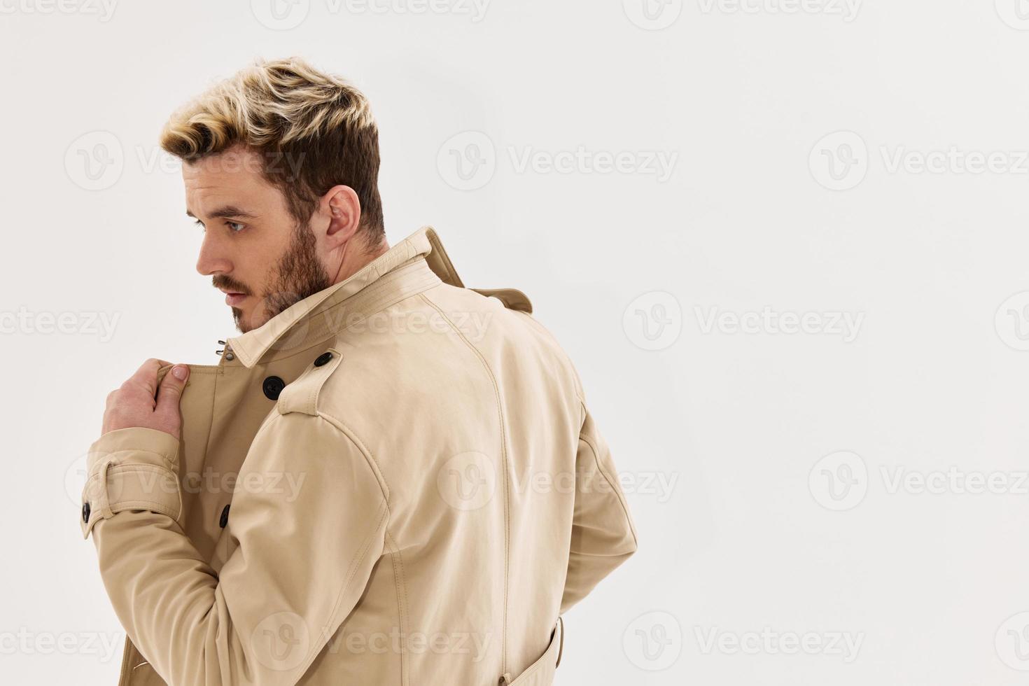 bearded man with fashionable hairstyle beige coat modern style photo