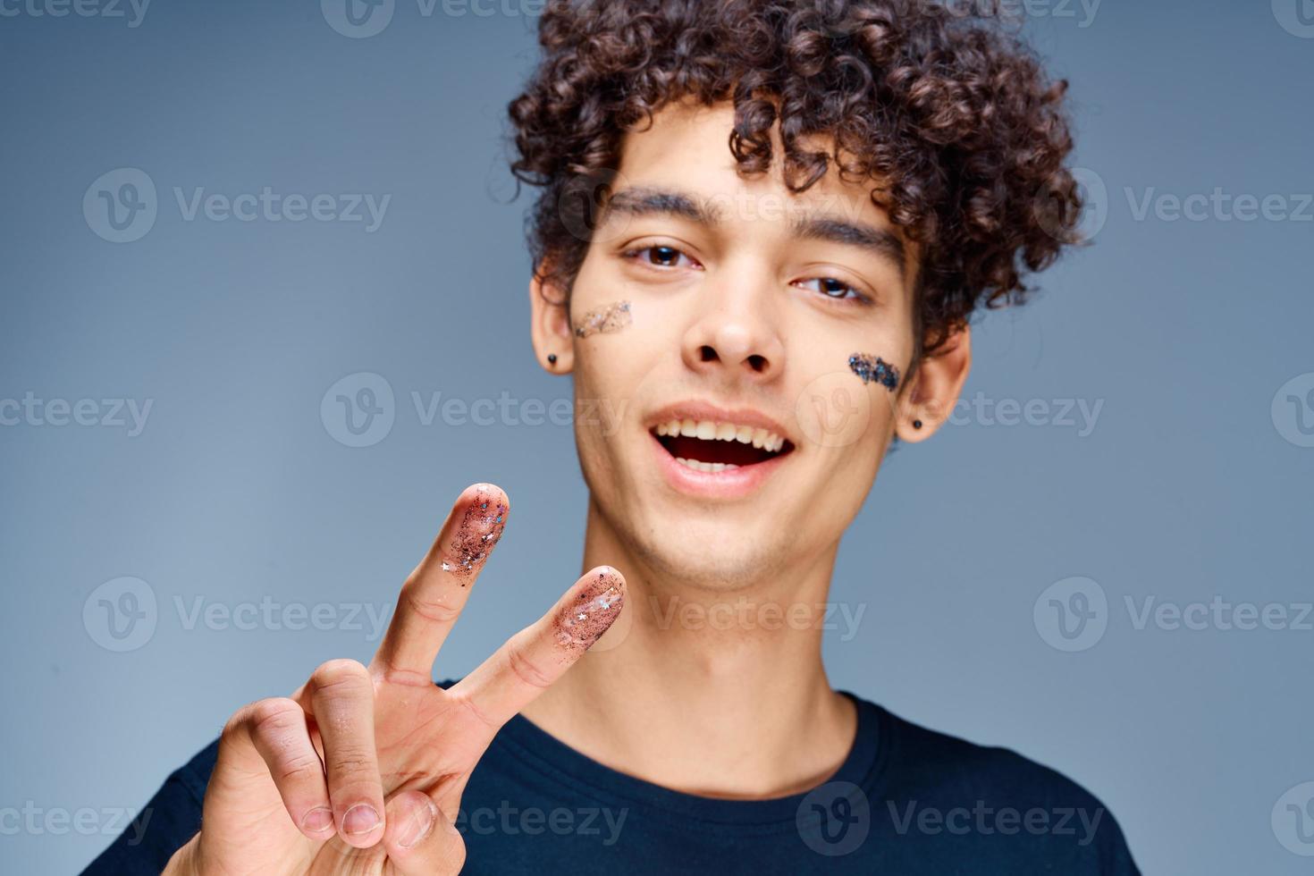 Cheerful man with curly hair cosmetics on face clean skin photo