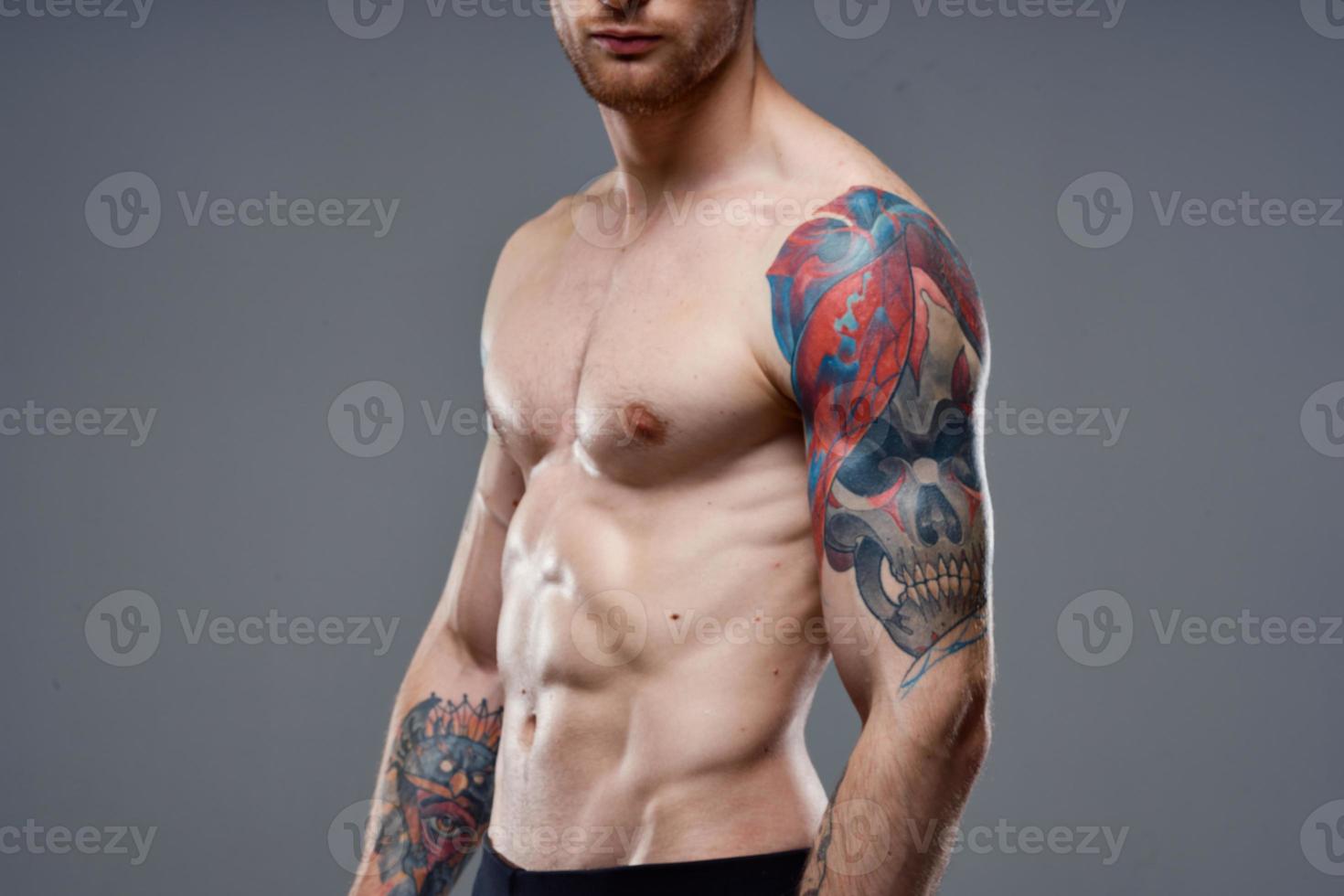 man with pumped up press tattoo on his arms cropped view of workout photo