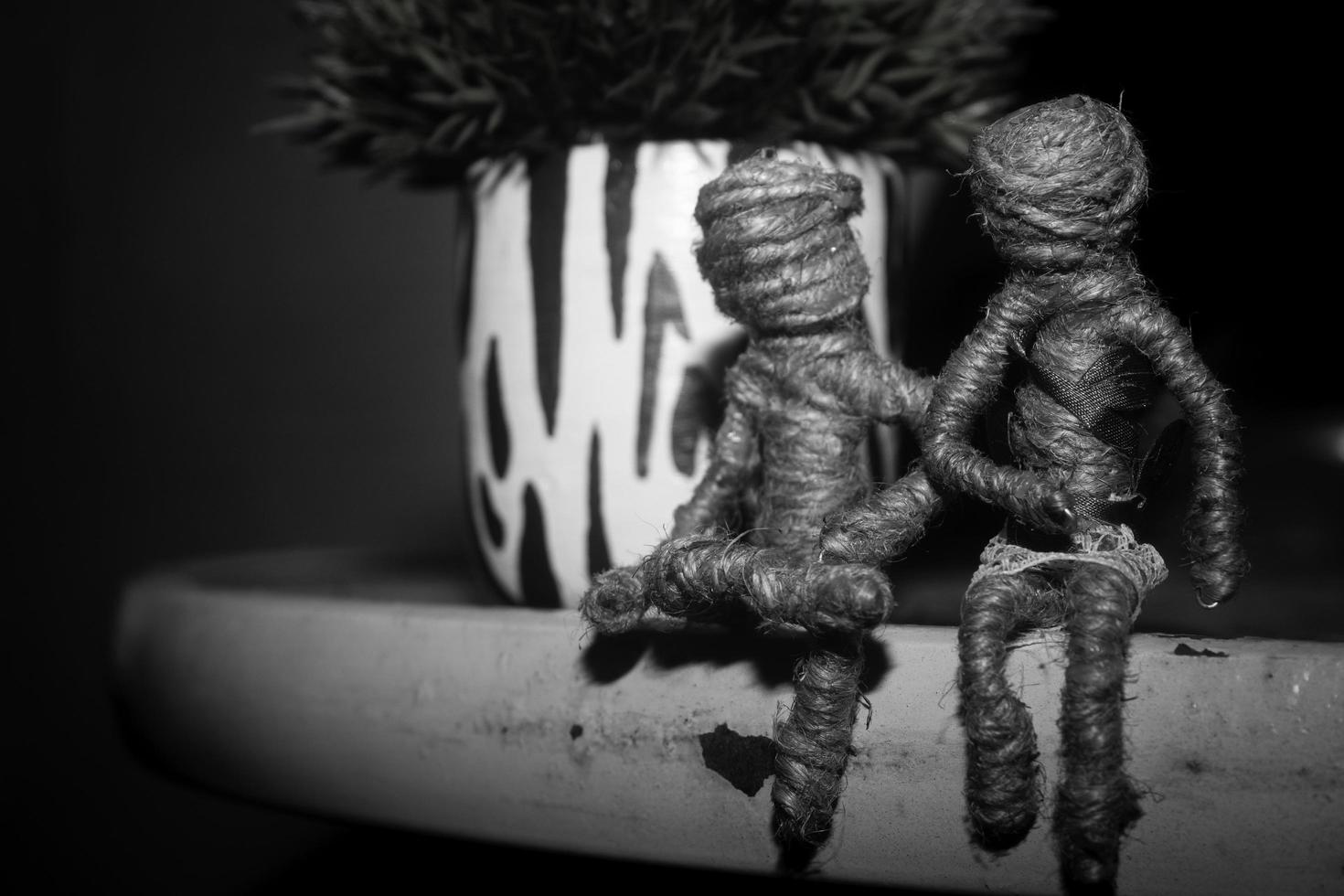 voodoo Dolls couple sitting on table glass. romantic wallpaper and background photography in black and white color photo