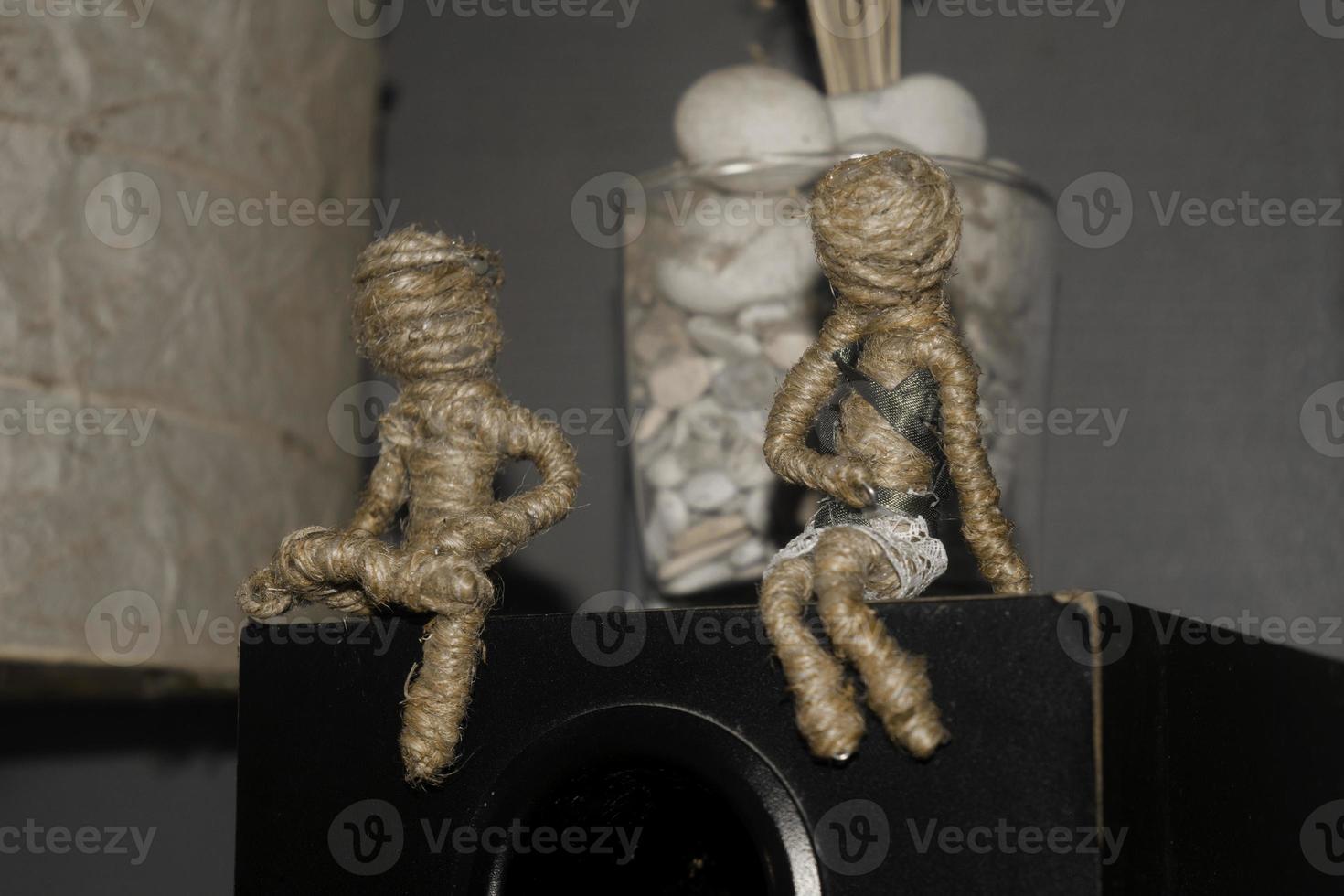 voodoo couple dolls sitting on sound system box. romantic scene photography concept photo