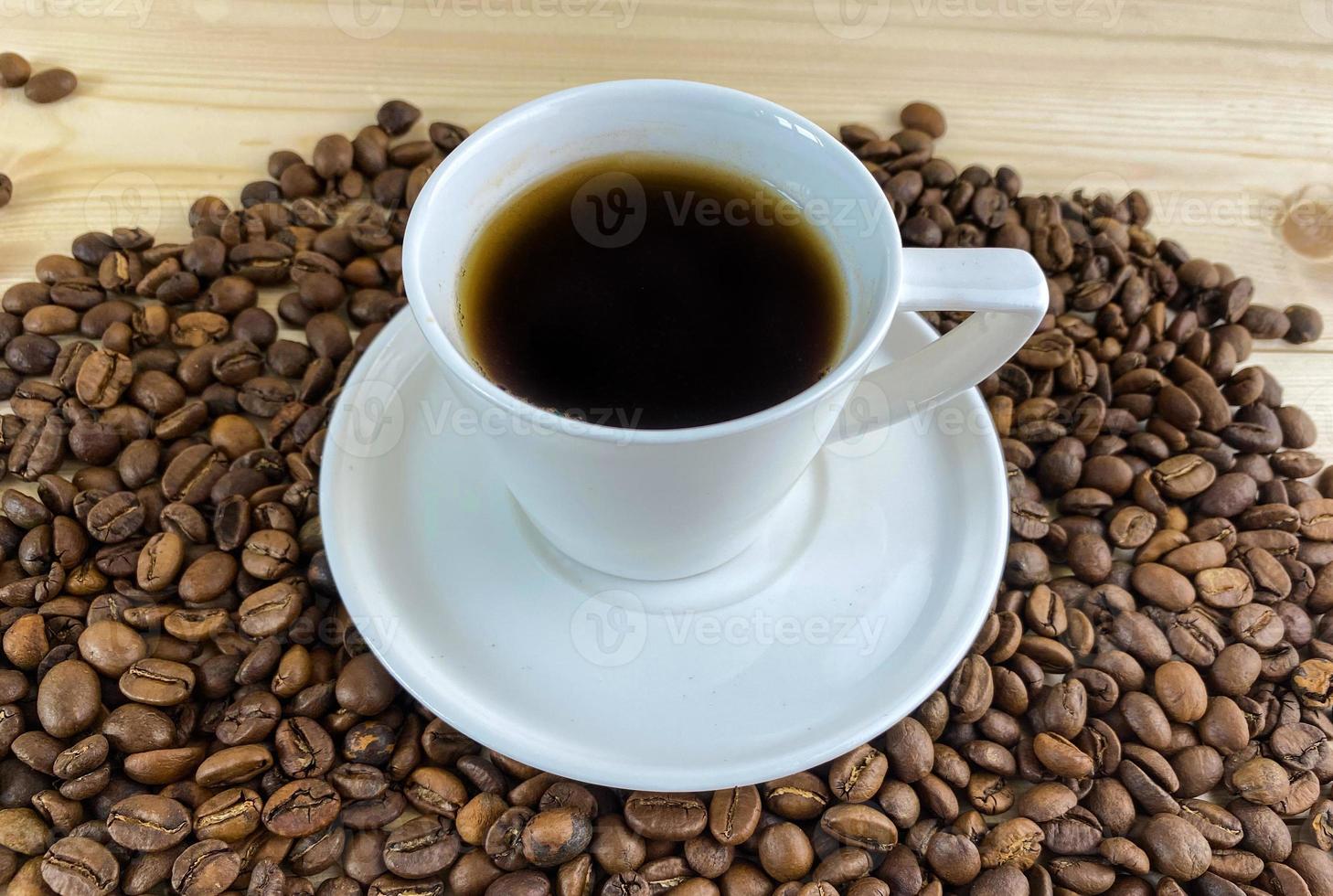 Coffee in a cup with a saucer and coffee grains. photo