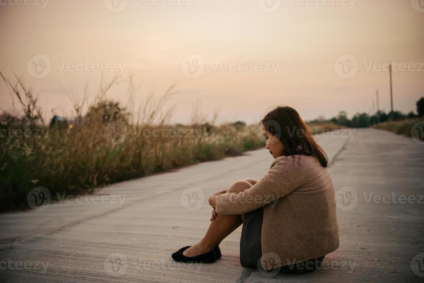 Portrait of lonely woman alone in a field. Vintage filter style.she heartbreak from love,sad girl concept on sunset vintage style photo