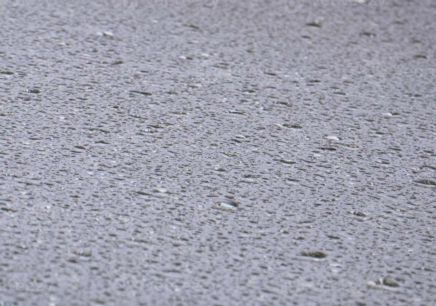 Close-up view on water drops on window in rain. Drops of rain on the glass concept photo. Front view photography with blurred background. photo
