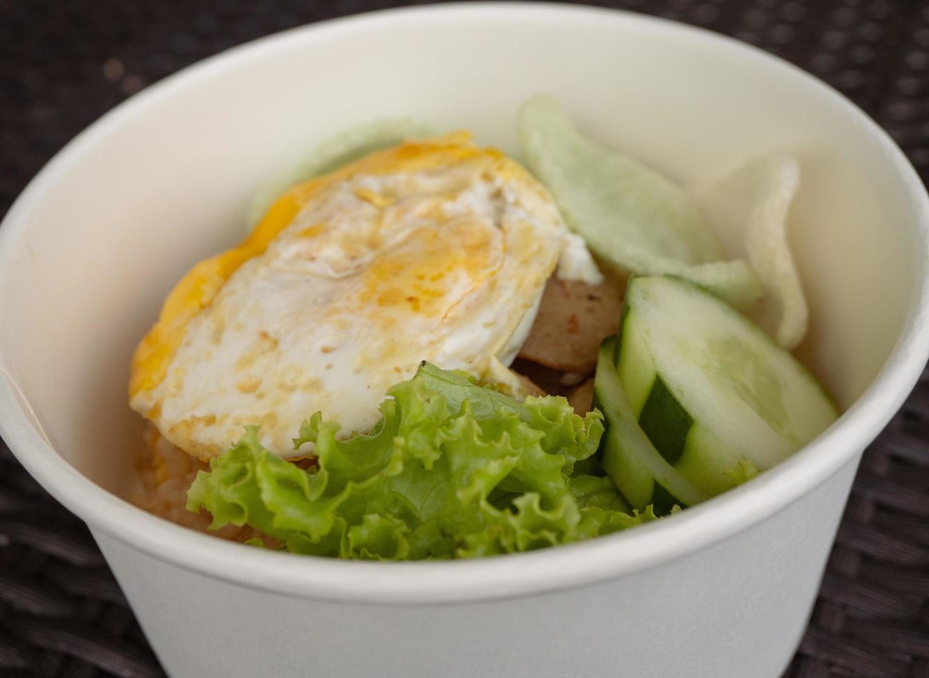 Close up photo fried rice with eggs and lettuce. The photo is suitable to use for traditional food background, poster and food content media.