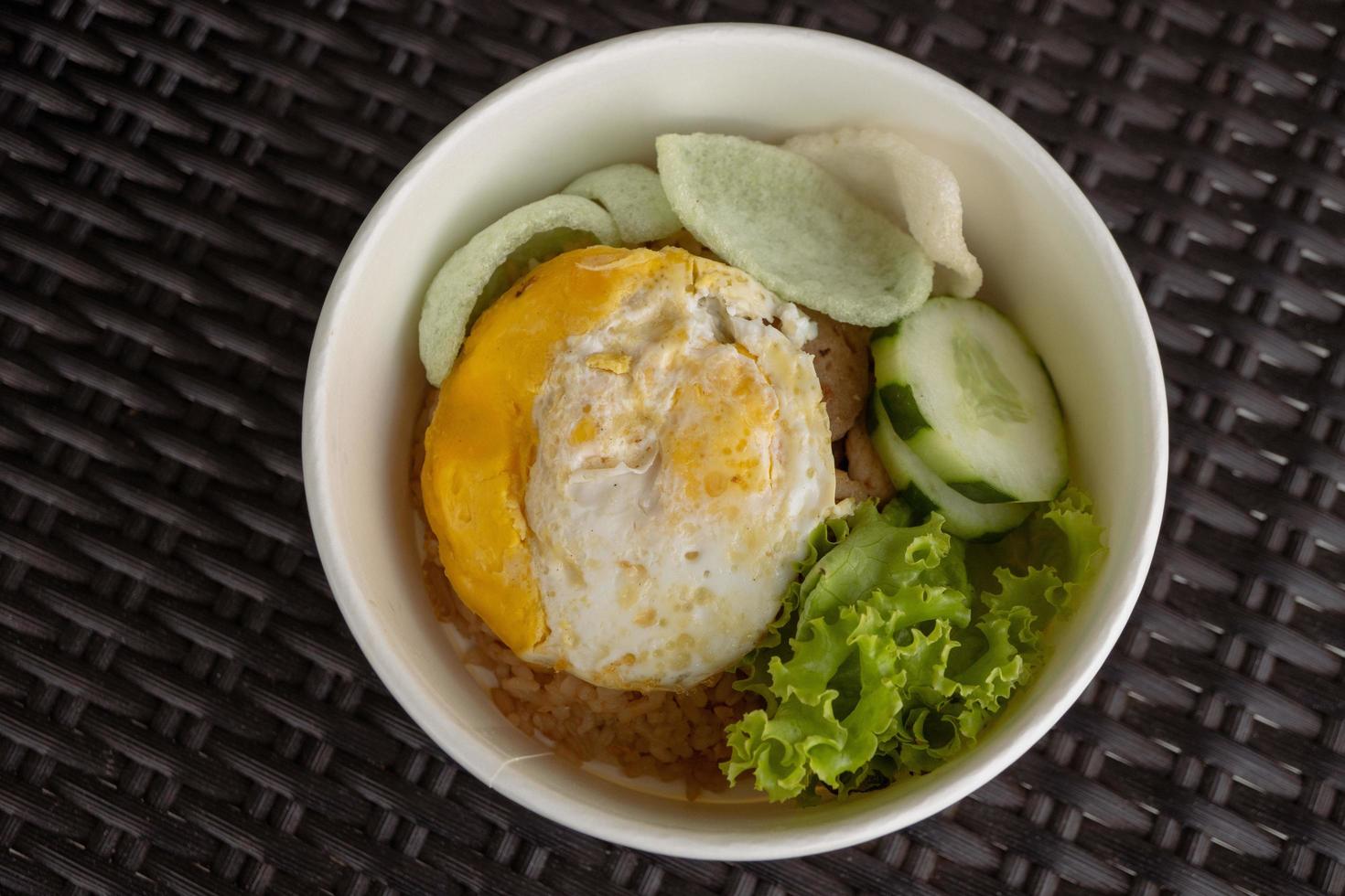 Close up photo fried rice with eggs and lettuce. The photo is suitable to use for traditional food background, poster and food content media.