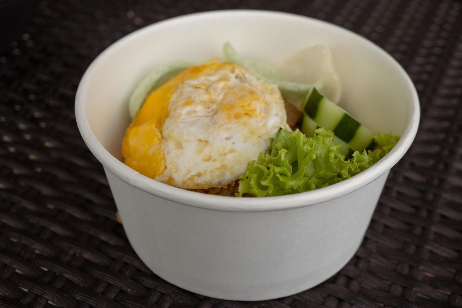 Close up photo fried rice with eggs and lettuce. The photo is suitable to use for traditional food background, poster and food content media.