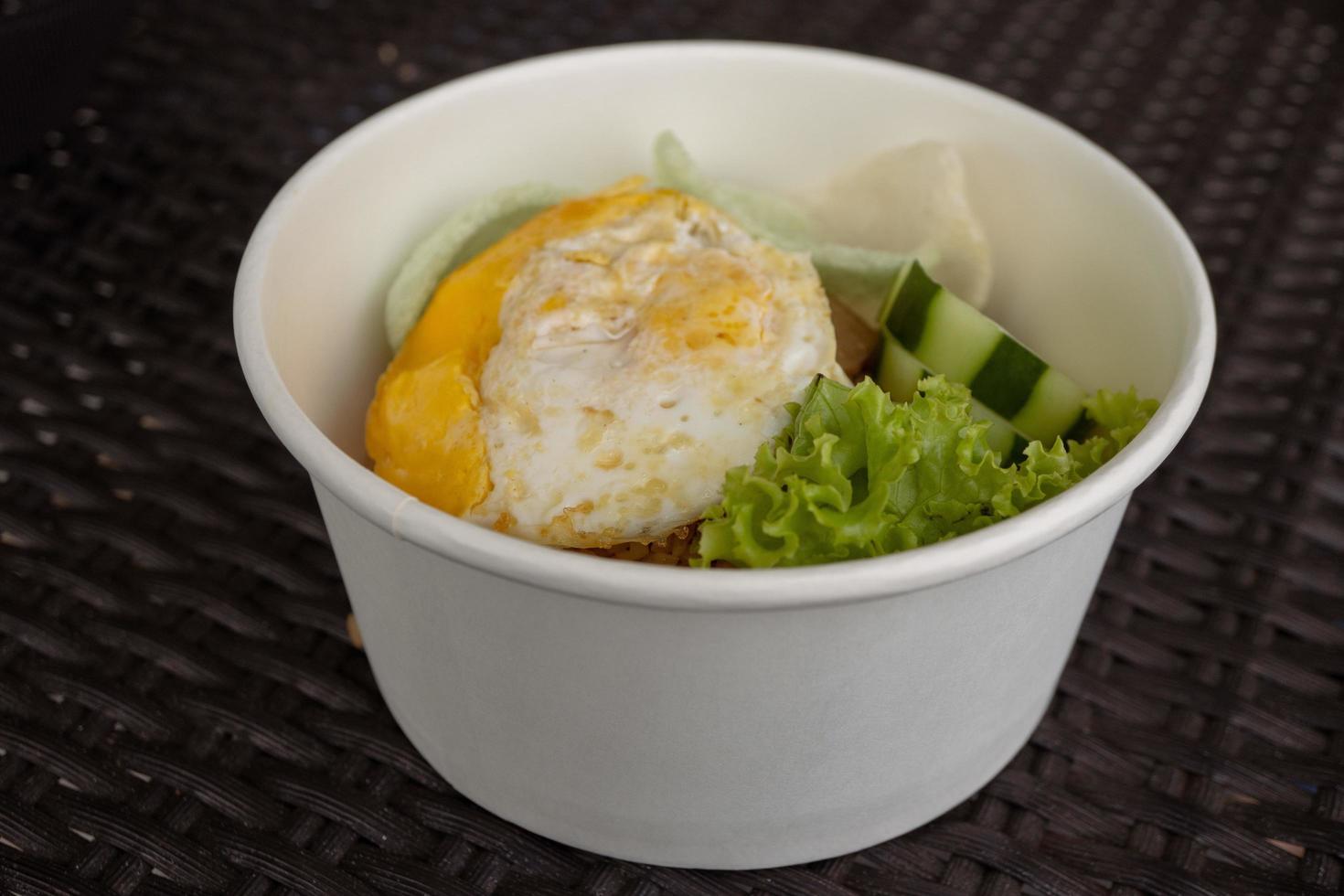 Close up photo fried rice with eggs and lettuce. The photo is suitable to use for traditional food background, poster and food content media.