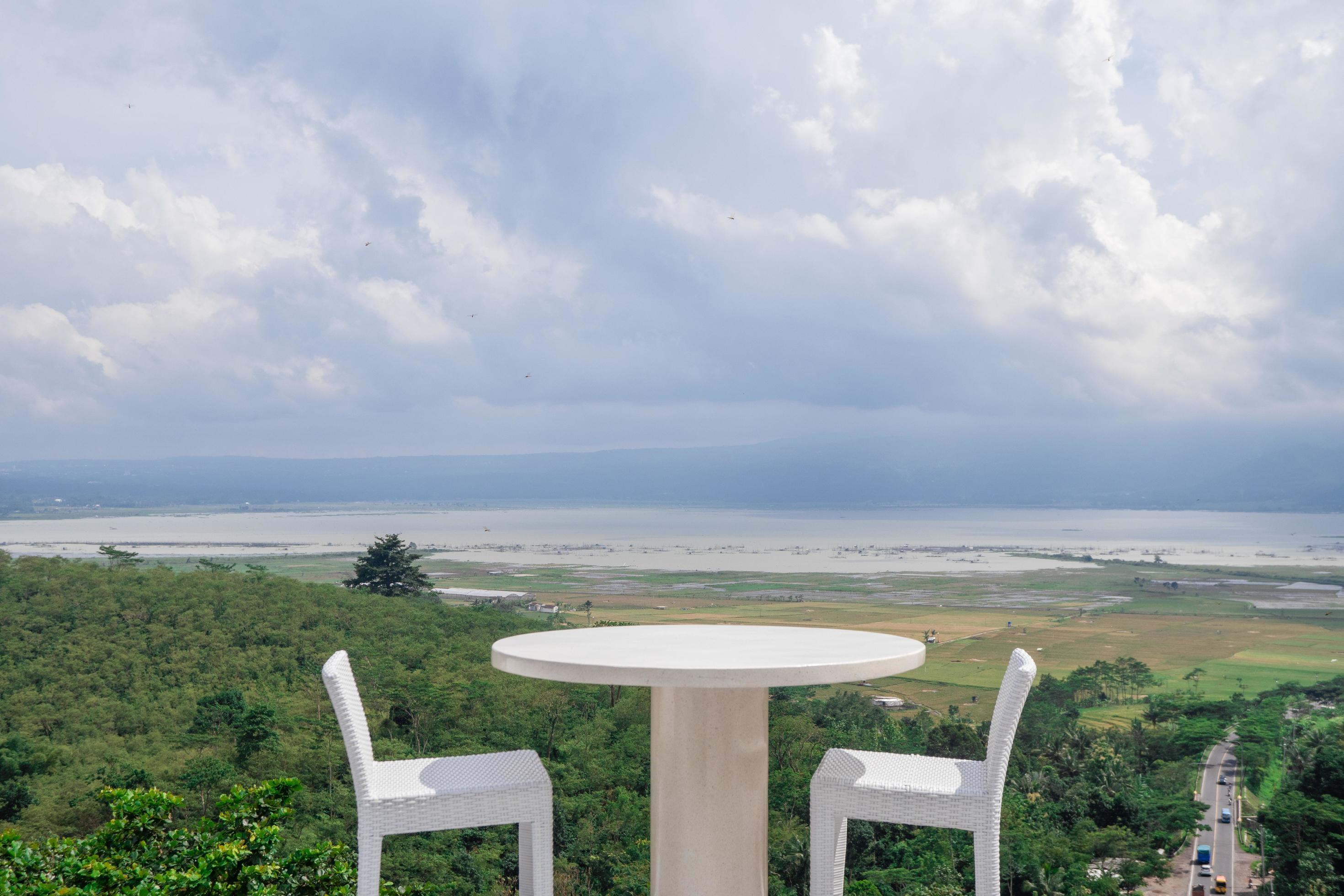 Empty white chair and table with beautiful background and cloudy sky