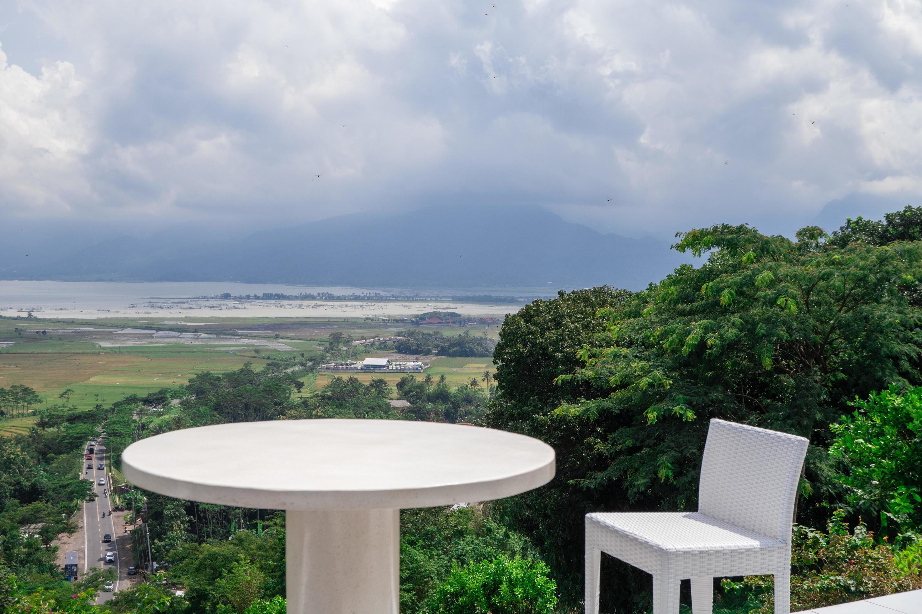Empty white chair and table with beautiful background and cloudy sky