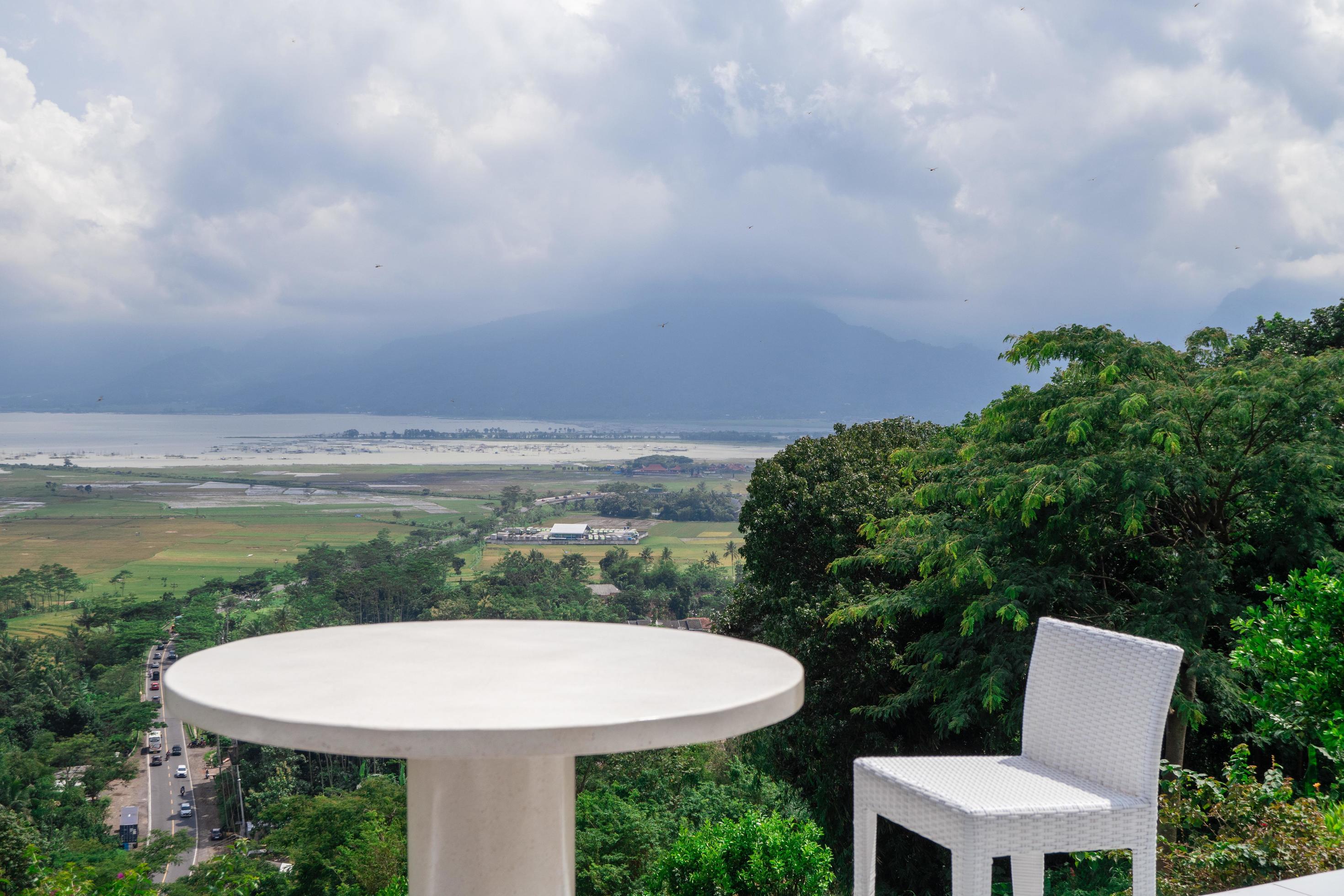 Empty white chair and table with beautiful background and cloudy sky