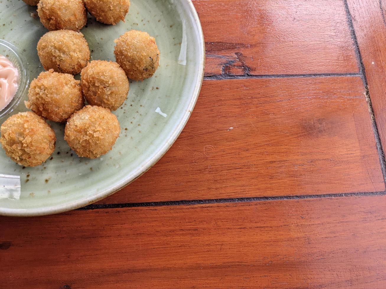 Chicken Ball on the green plate with mayonnaise sauce, snack menu on coffee shop. The photo is suitable to use for traditional food background, poster and food content media.