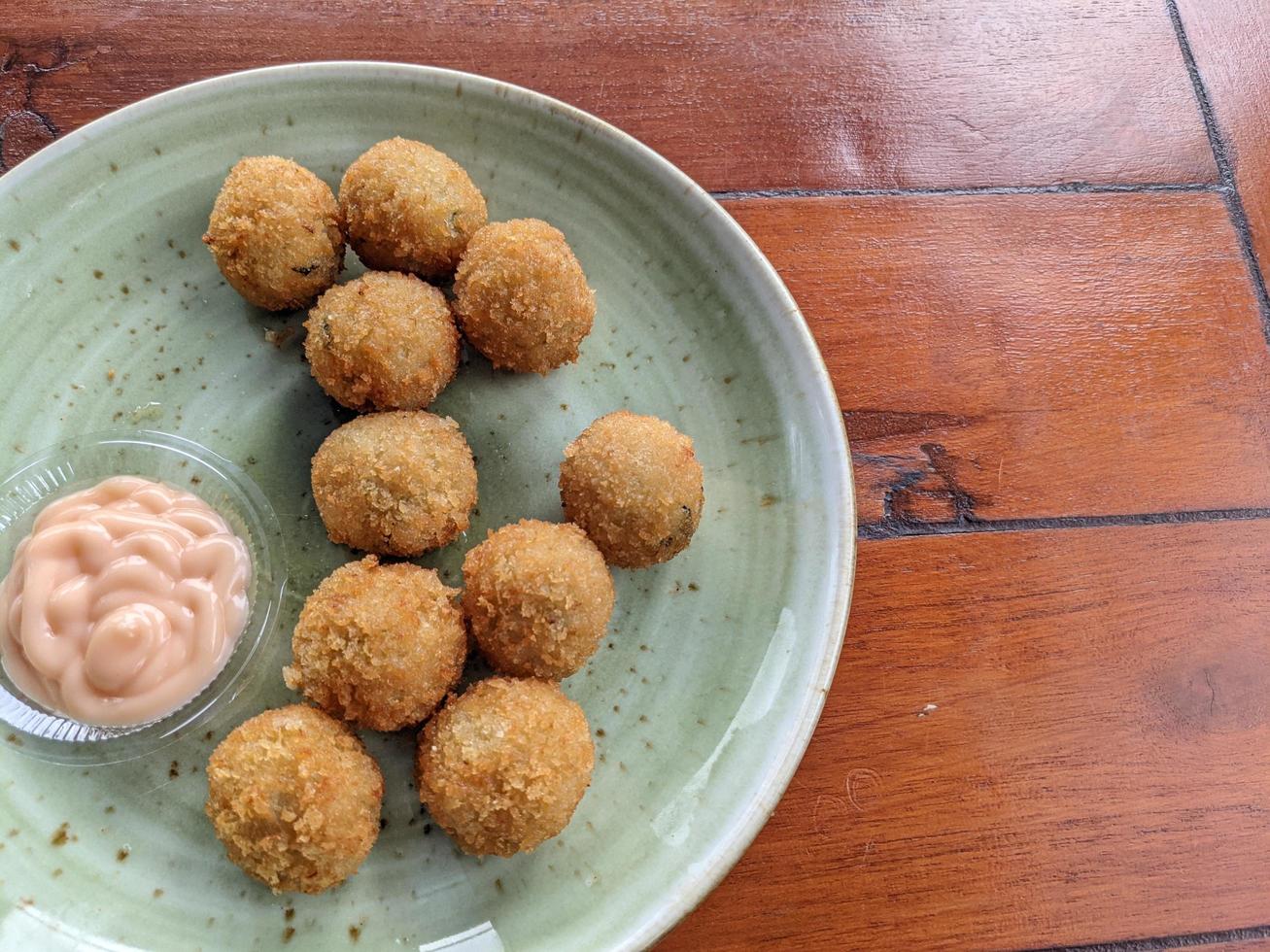 Chicken Ball on the green plate with mayonnaise sauce, snack menu on coffee shop. The photo is suitable to use for traditional food background, poster and food content media.