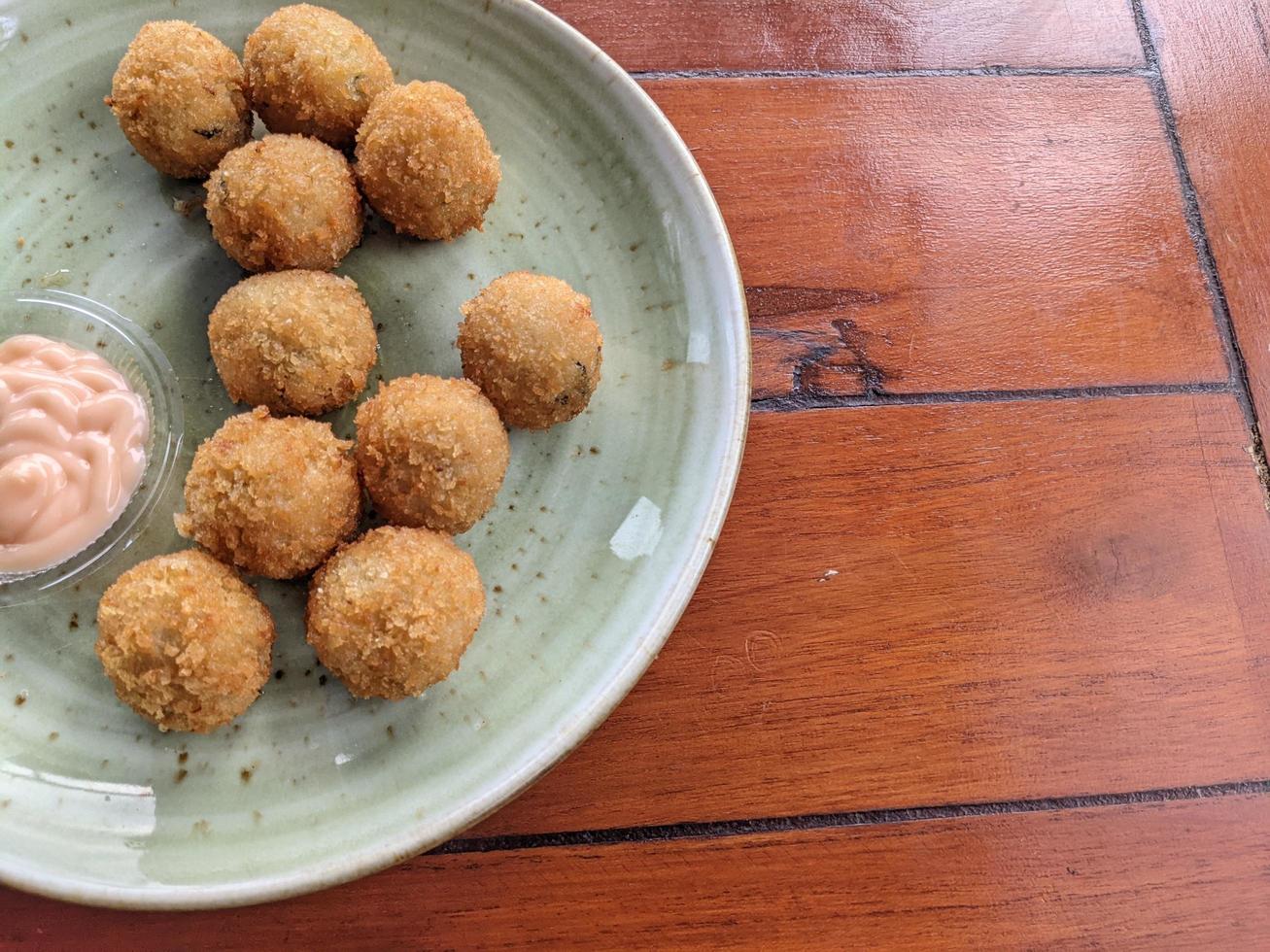 Chicken Ball on the green plate with mayonnaise sauce, snack menu on coffee shop. The photo is suitable to use for traditional food background, poster and food content media.