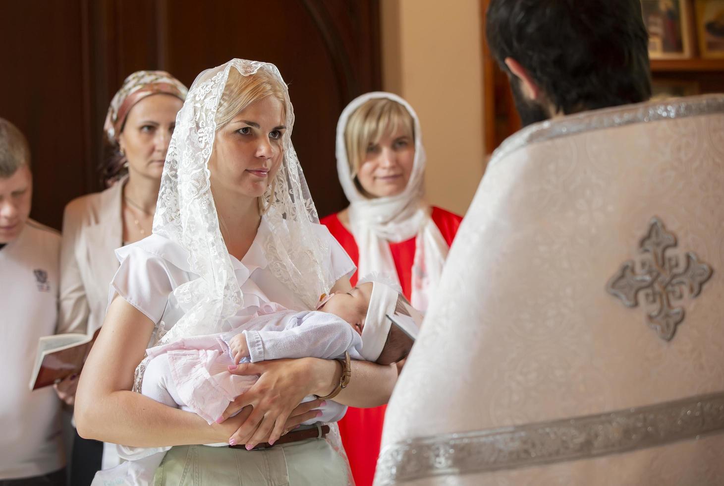 Belarus, the city of Gomel. June 10, 2017. Church at the regional hospital. The baptism of a child.The mother holds the child on her hands during the rite of baptism.Accept religion photo