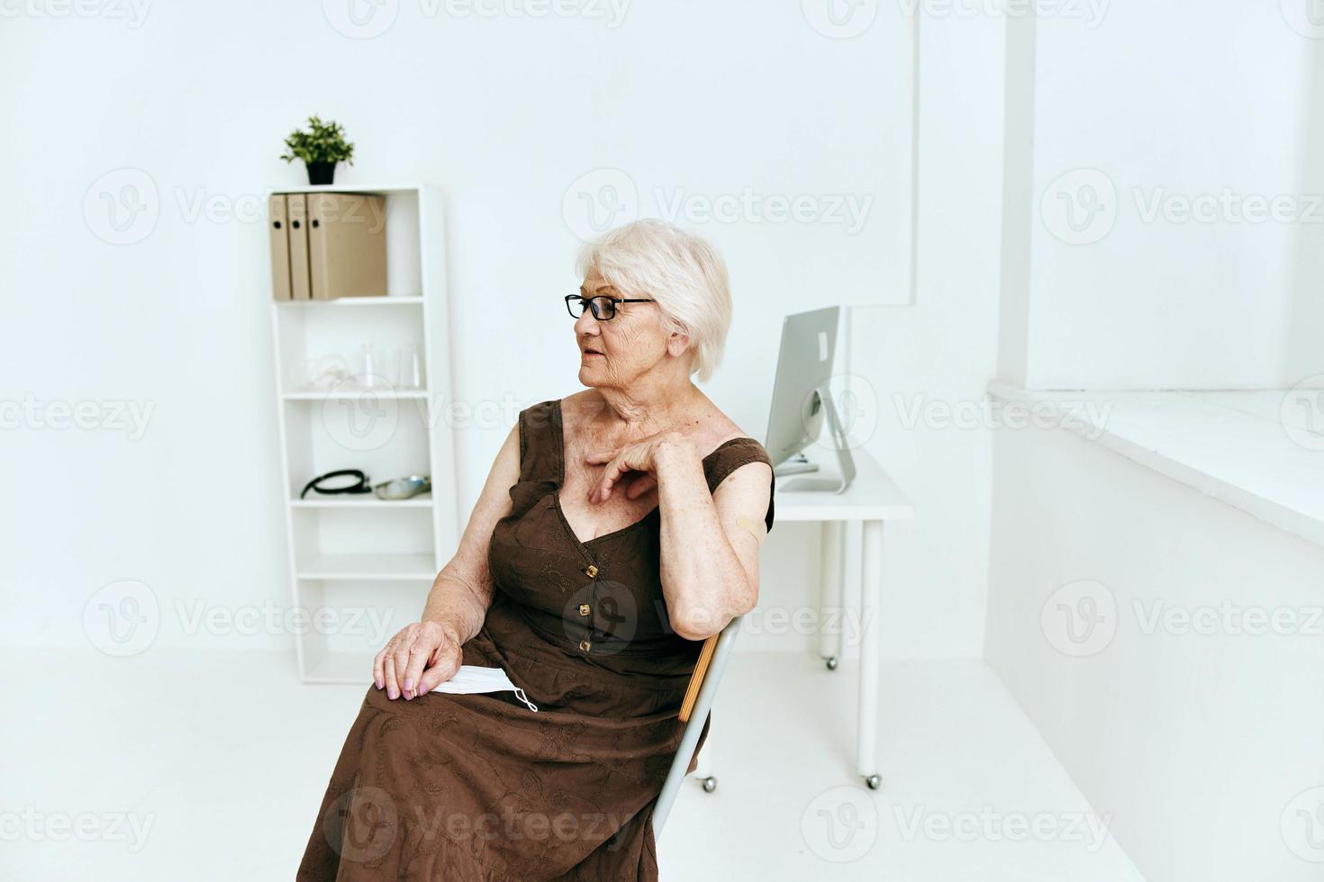 old woman in covid clinic passport immunization safety photo