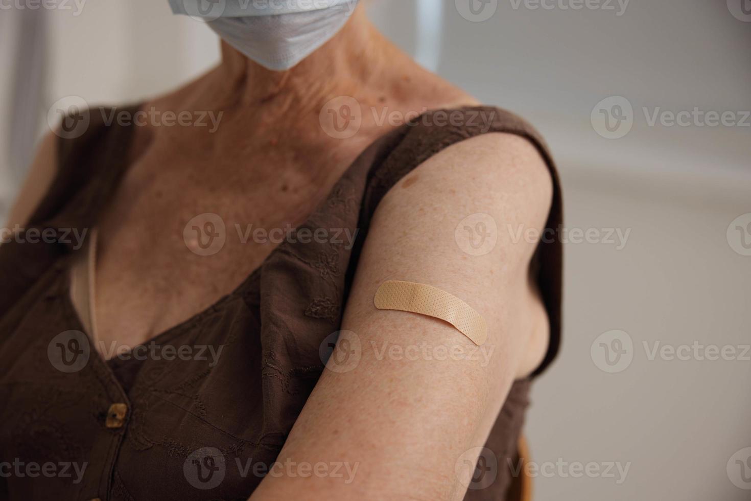 elderly woman in clinic vaccine passport protection immunity close-up photo