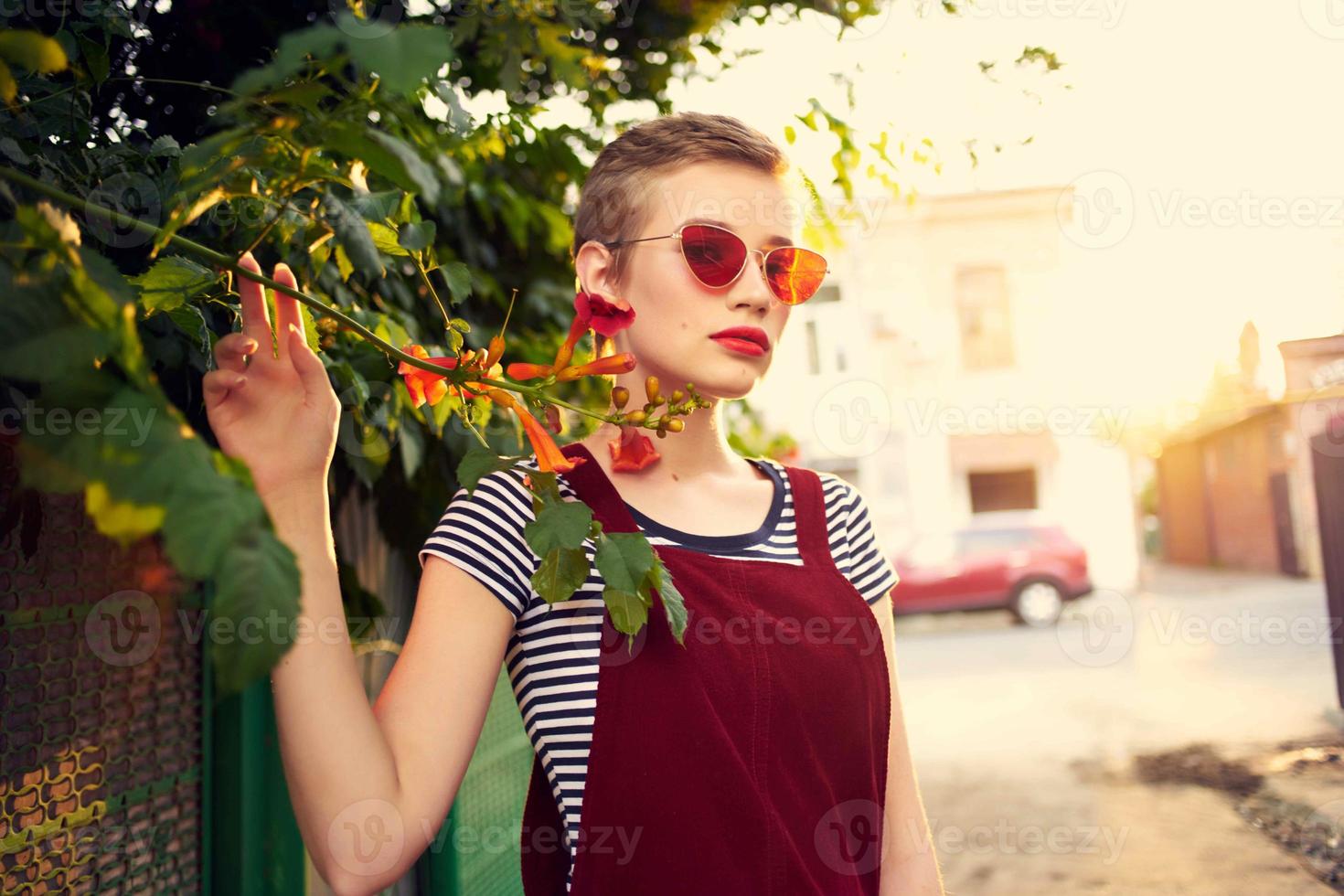 pretty woman wearing sunglasses outdoors fashion posing flowers photo