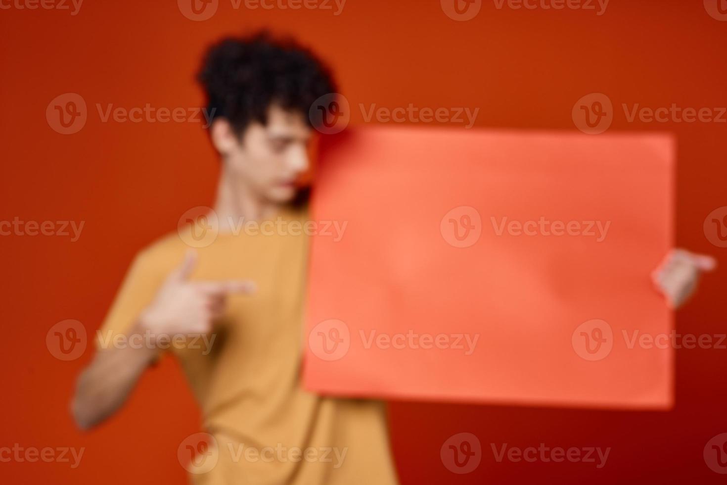 guy with curly hair studio advertising mockup red background photo