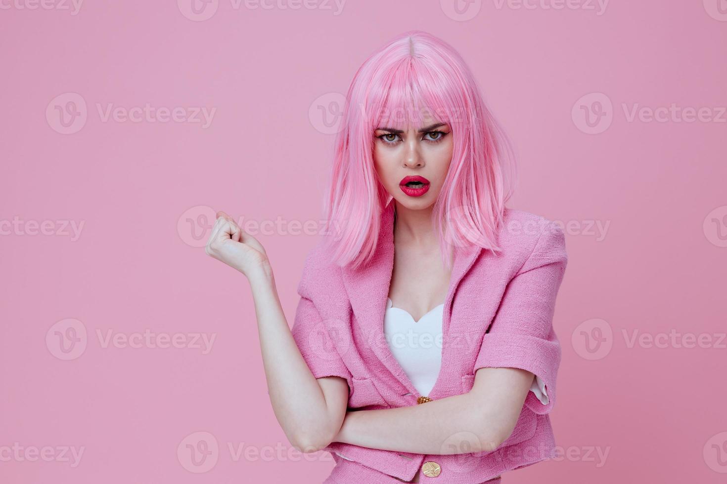 Positive young woman gesturing with hands pink jacket lifestyle glamor color background unaltered photo