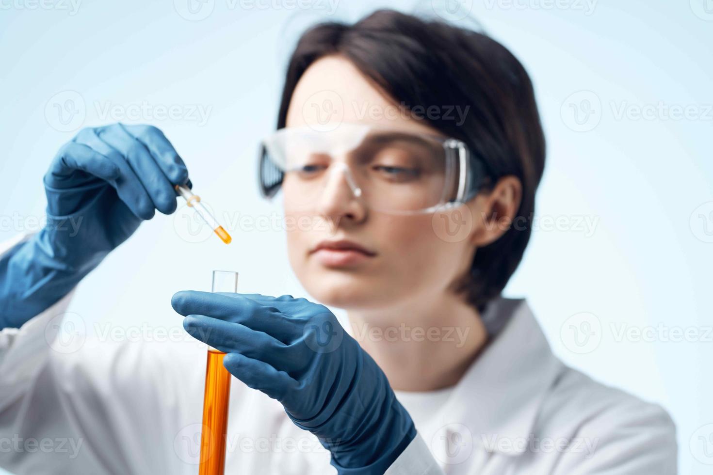 Woman in white coat test tube chemical solution analysis diagnostics photo