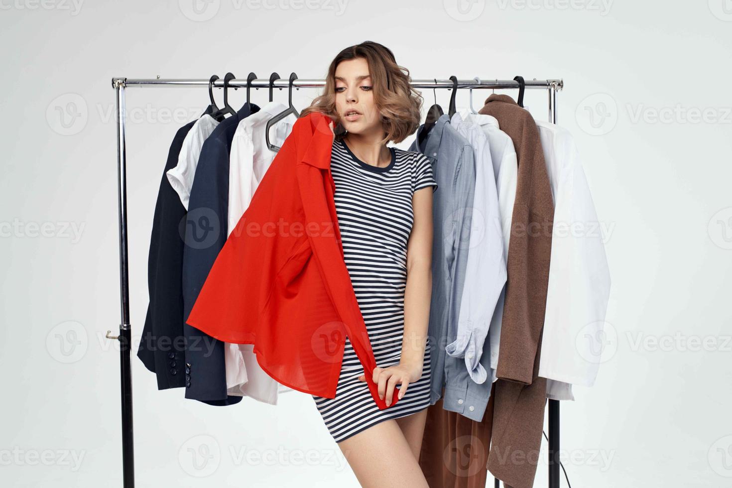 pretty woman near clothes shopaholic isolated background photo