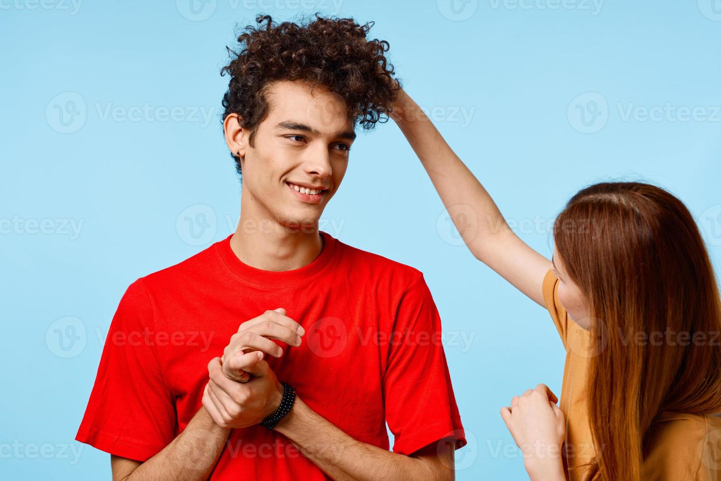 young couple cropped view studio blue background communication photo