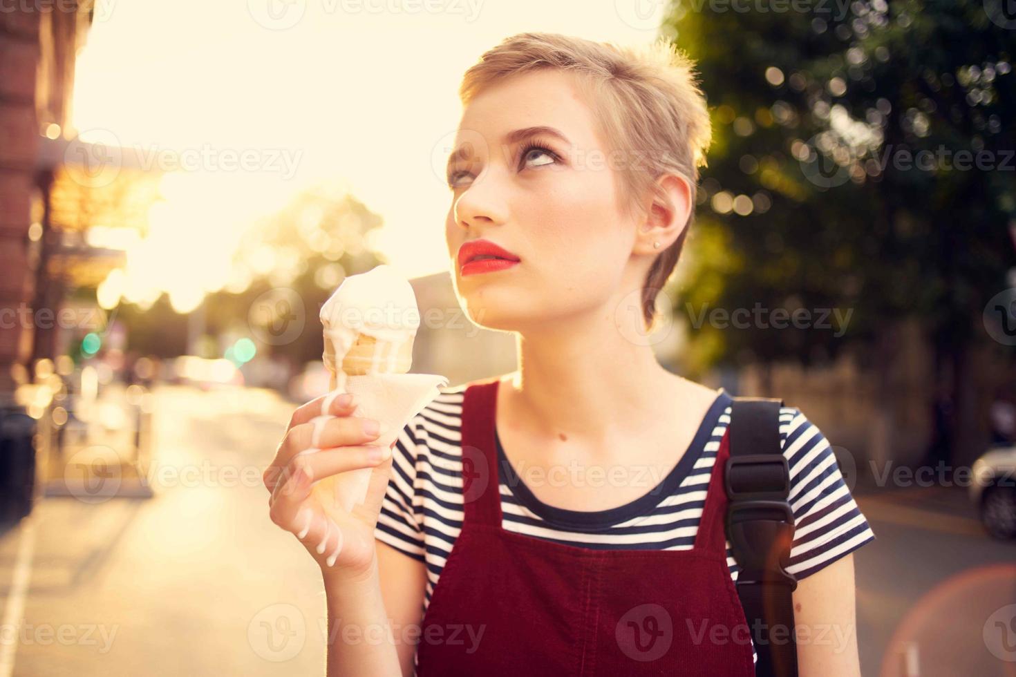 short haired woman outdoors eating ice cream walk lifestyle photo