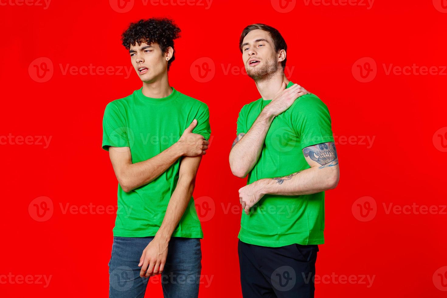 two friends cover their hand face emotions displeasure red background photo