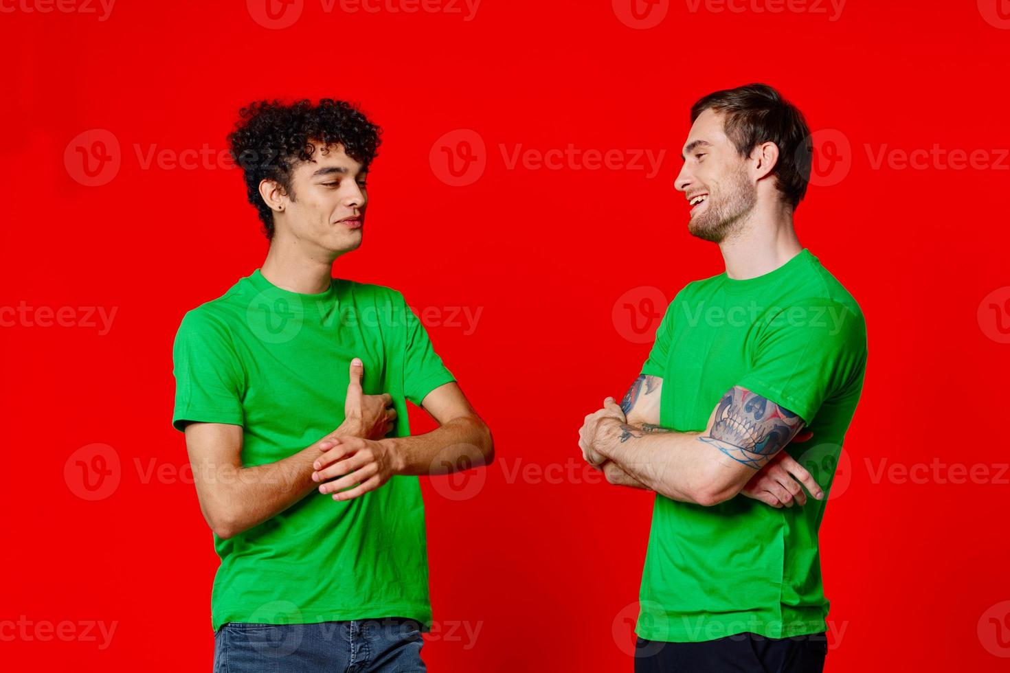Cheerful friends are standing next to communication fun red background photo