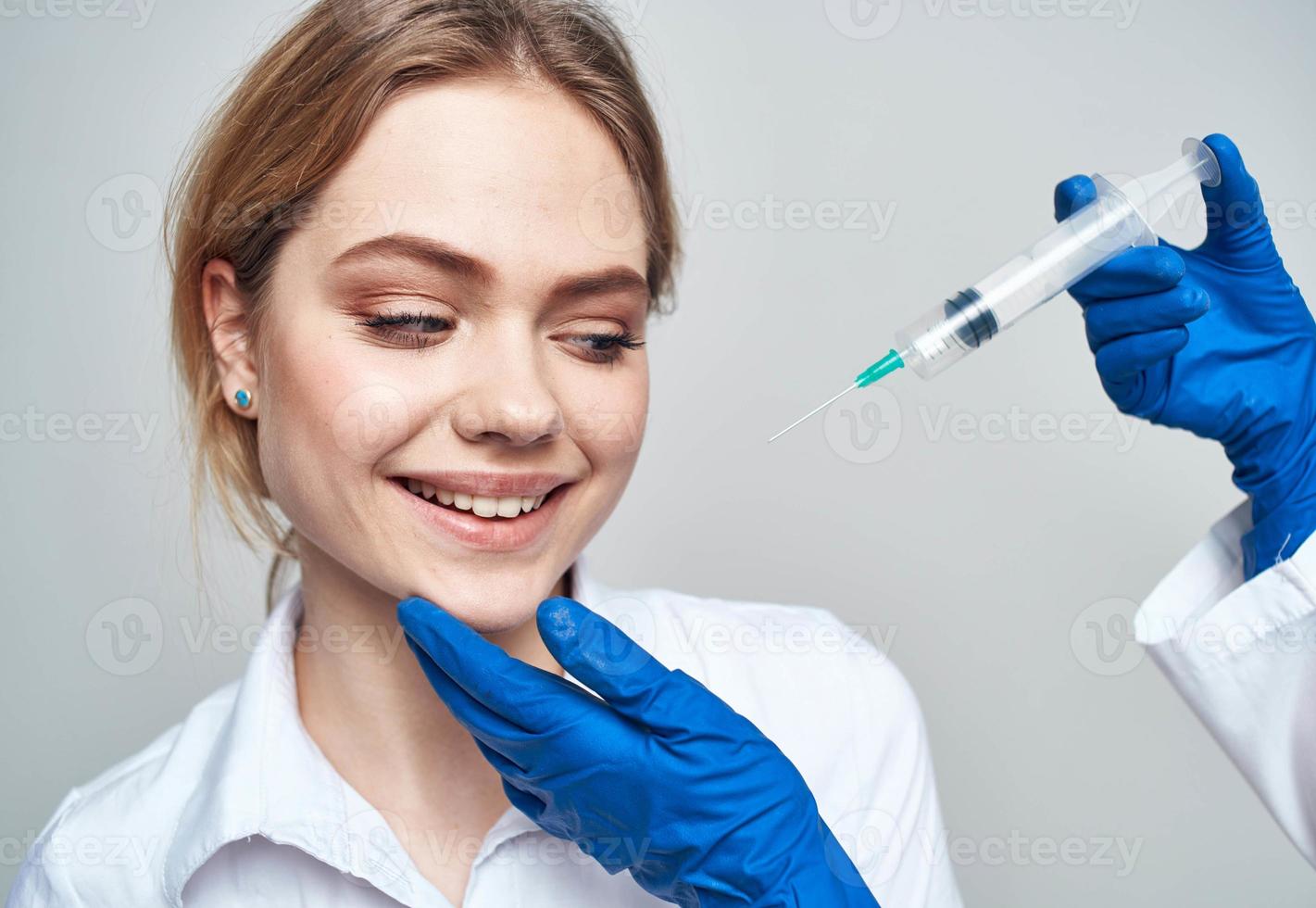 Scared woman and syringe in the hands of the doctor shock emotions model photo