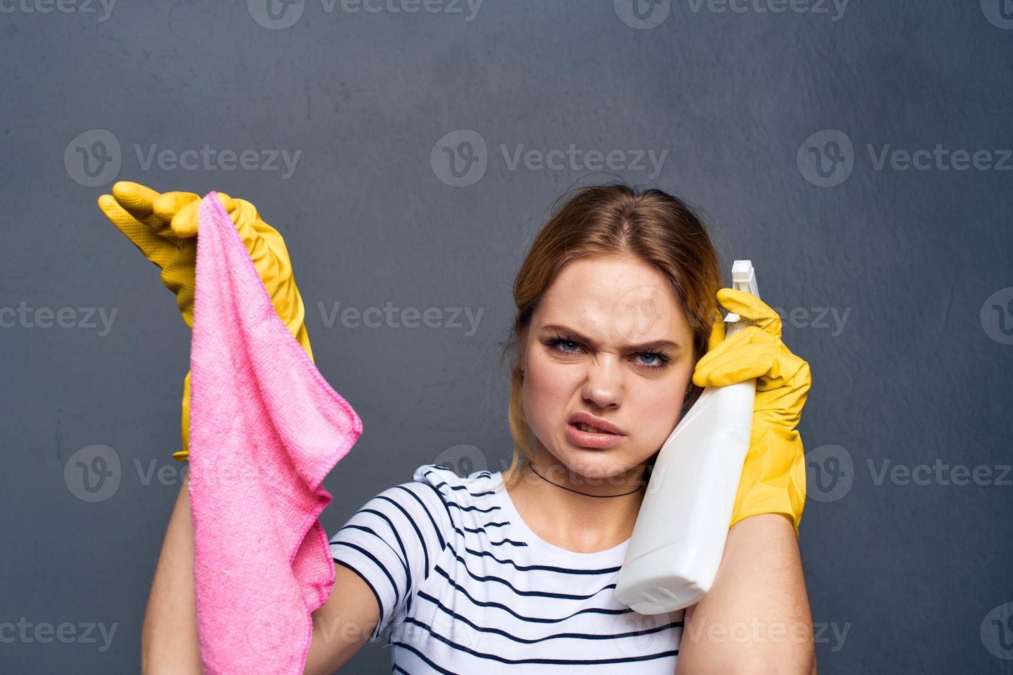 cleaning lady with pink rag in hand home care service gray background photo