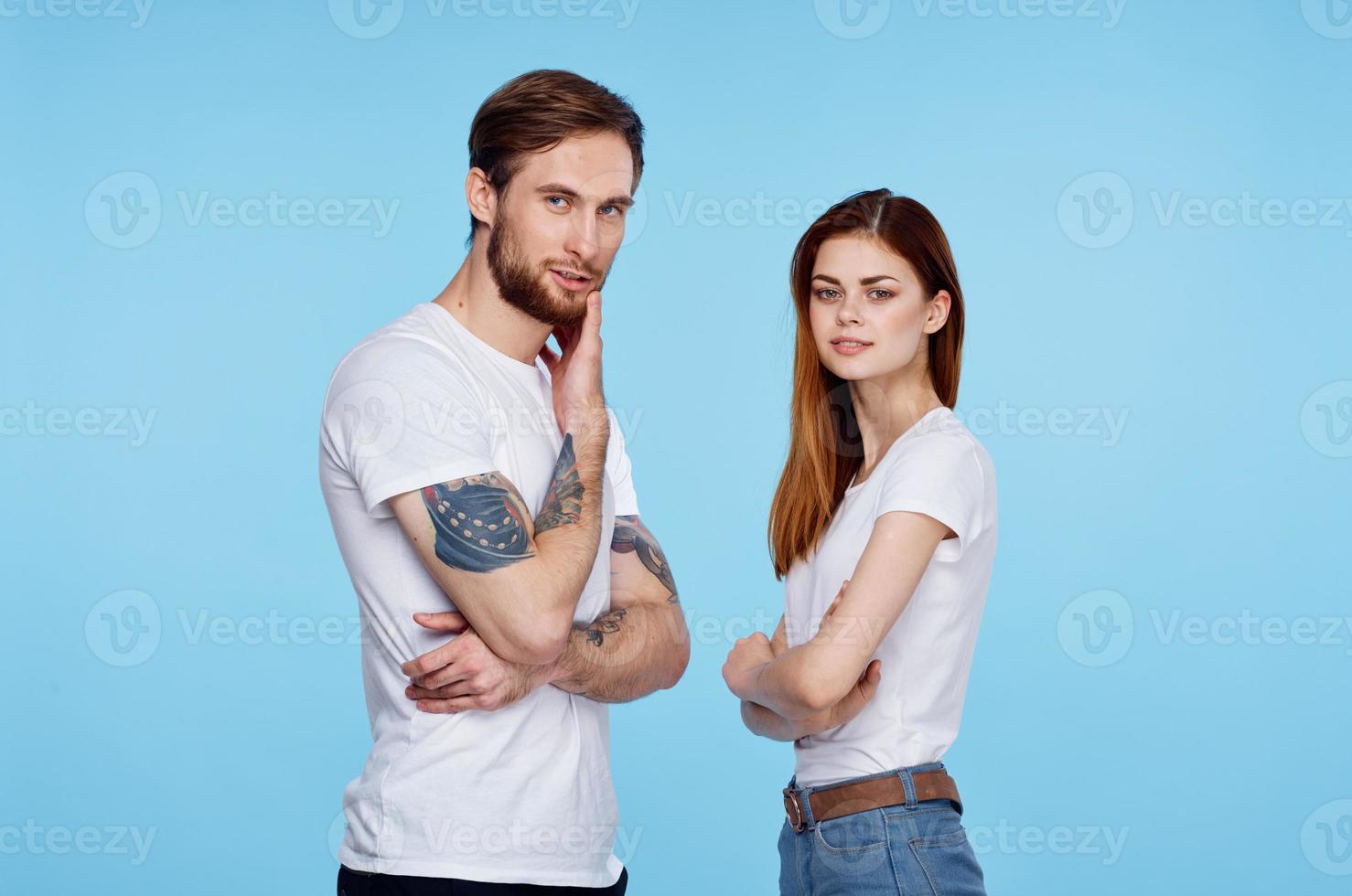 young couple in white t-shirts images of communication with him studio photo