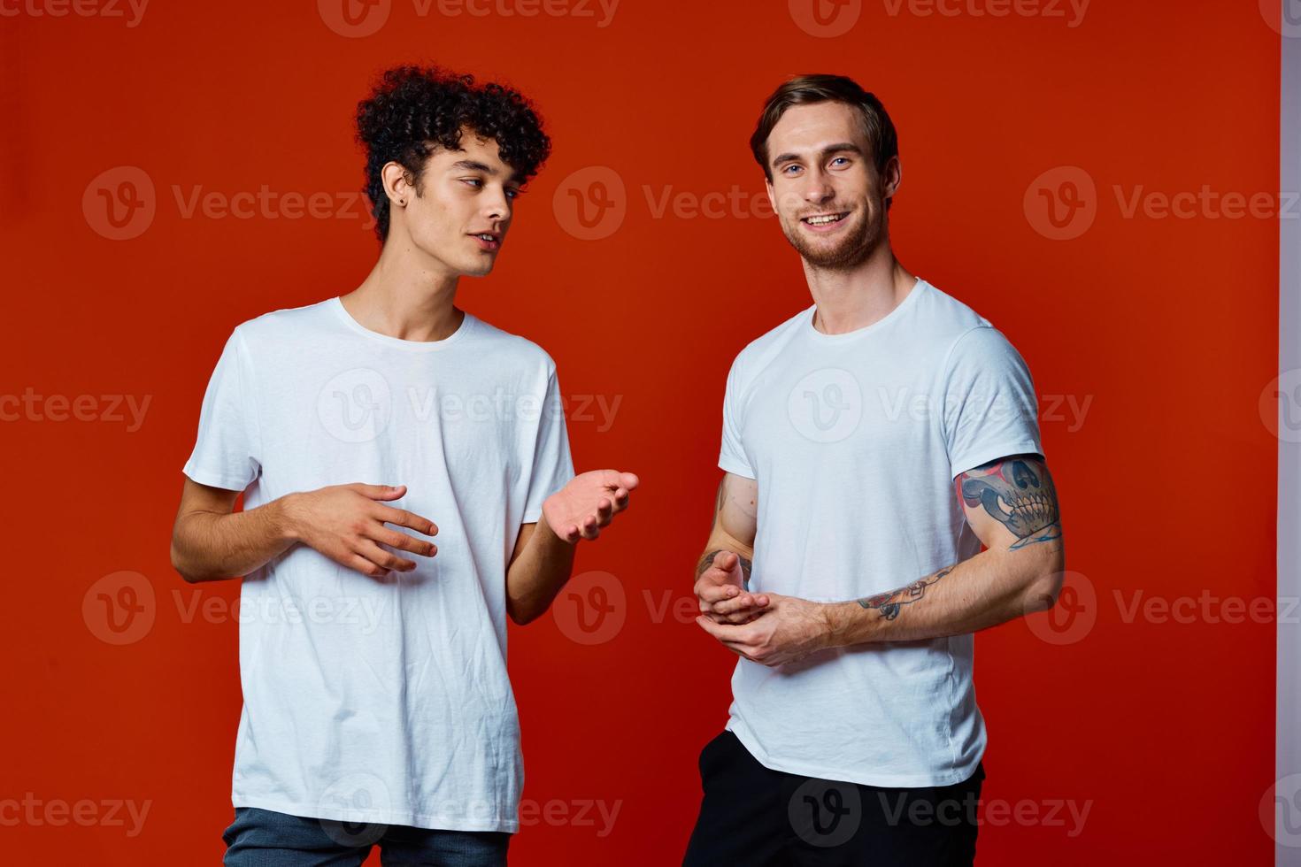 Two cheerful friends in white t-shirts communication isolated background fun photo
