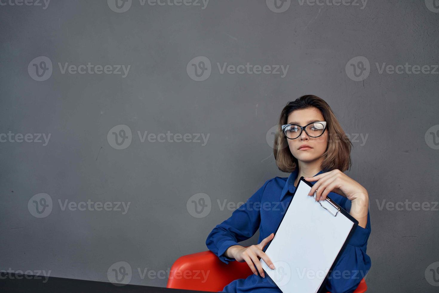 Business woman in blue shirt sits at the table photo