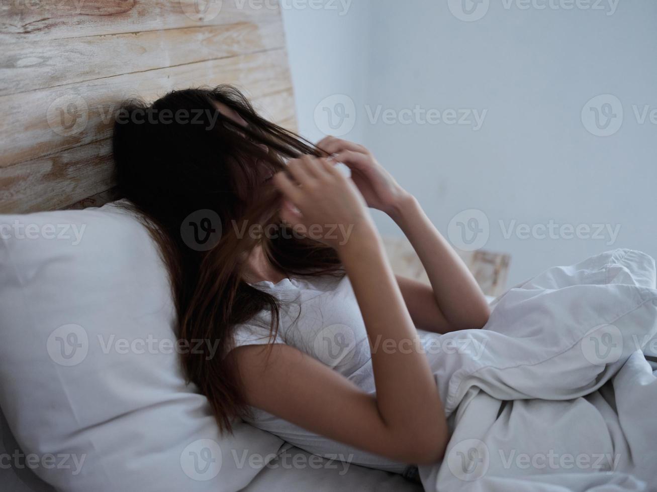 women are already in bed holding their hairs close-up dissatisfaction photo